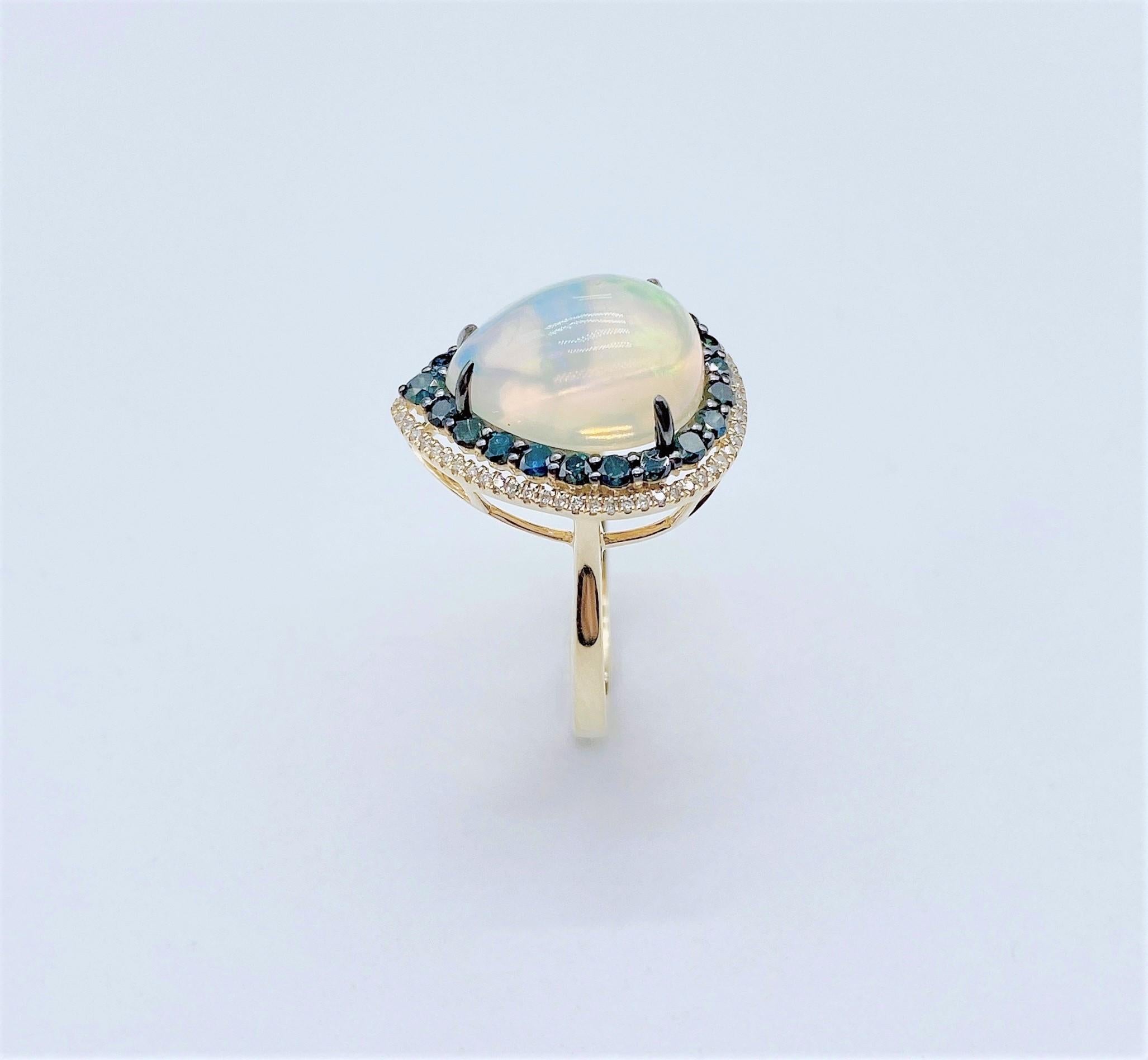 The Following Items we are offering is this Rare Important Radiant 18KT Gold LARGE Glittering and Sparkling Magnificent Fancy Colored Opal and Blue Sapphire White Diamond Ring. Ring Contains a Beautiful Gorgeous Large Opal surrounded with a Halo of