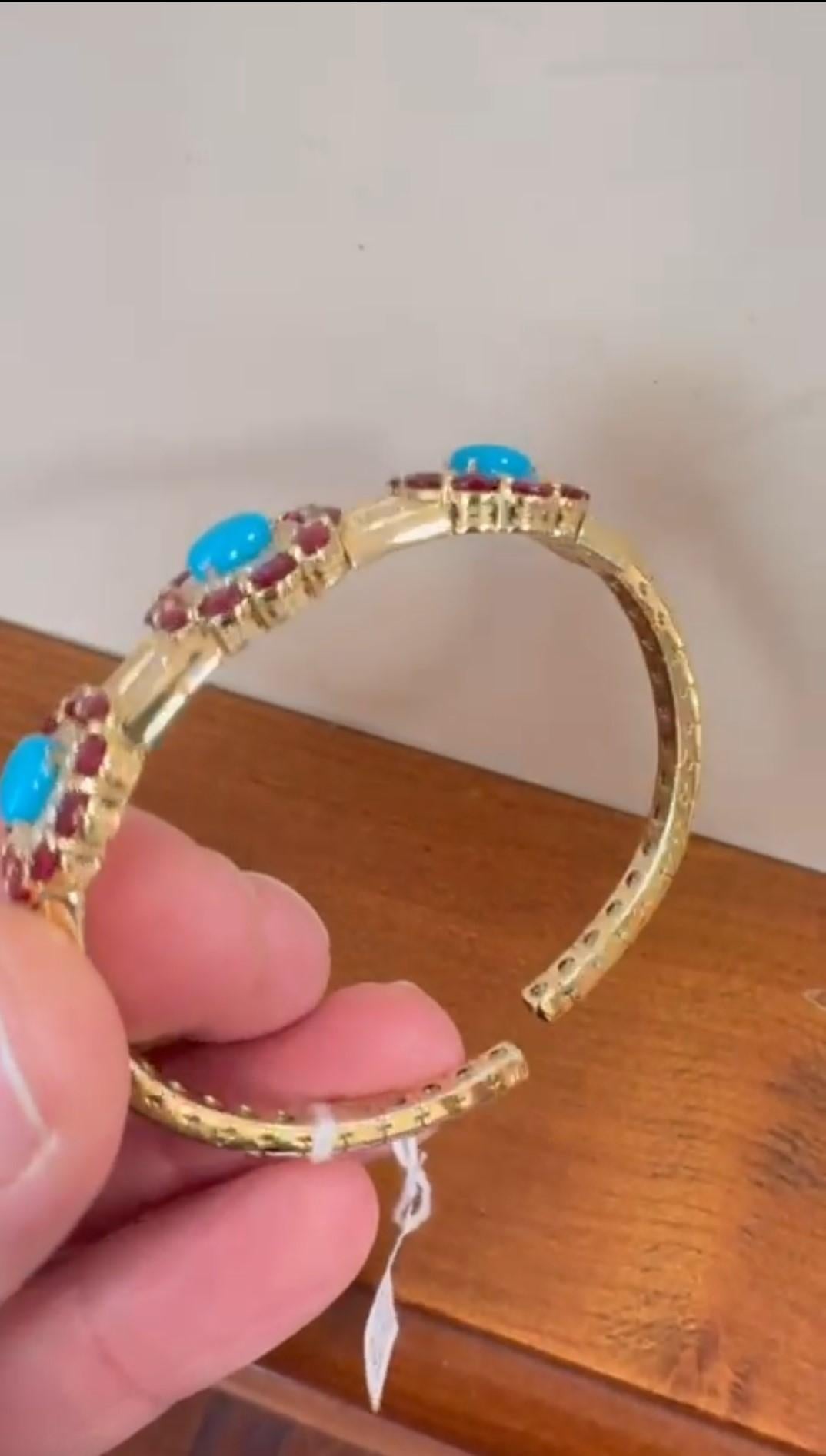L'article suivant que nous proposons est un Rare 18KT Gold Large Turquoise Diamond Ruby Bangle. Ce magnifique bracelet est composé d'une magnifique turquoise ovale finement sertie, encadrée de magnifiques diamants et rubis scintillants. Les rubis et