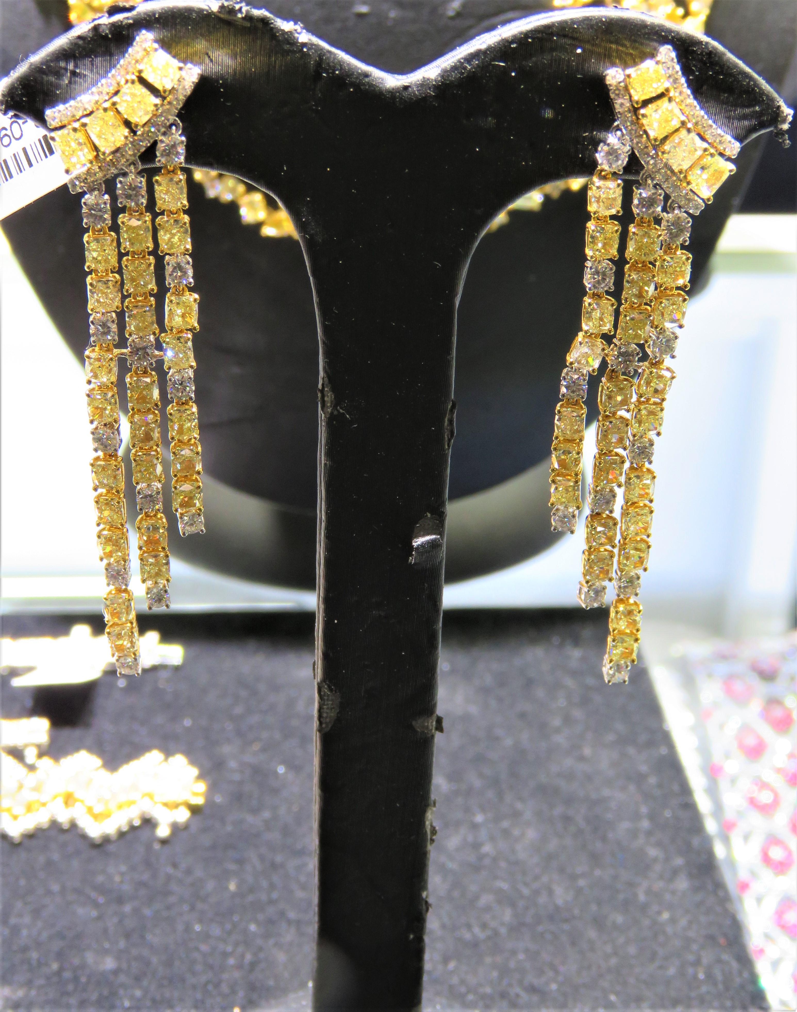 The Following Item we are offering are these Extremely Rare Beautiful 18KT Gold Fine Large Fancy Yellow and White Diamond Dangle Earrings. Each Earring features Rare Gorgeous Glittering Fancy Yellow Diamonds Draped with Sparkling White Diamonds