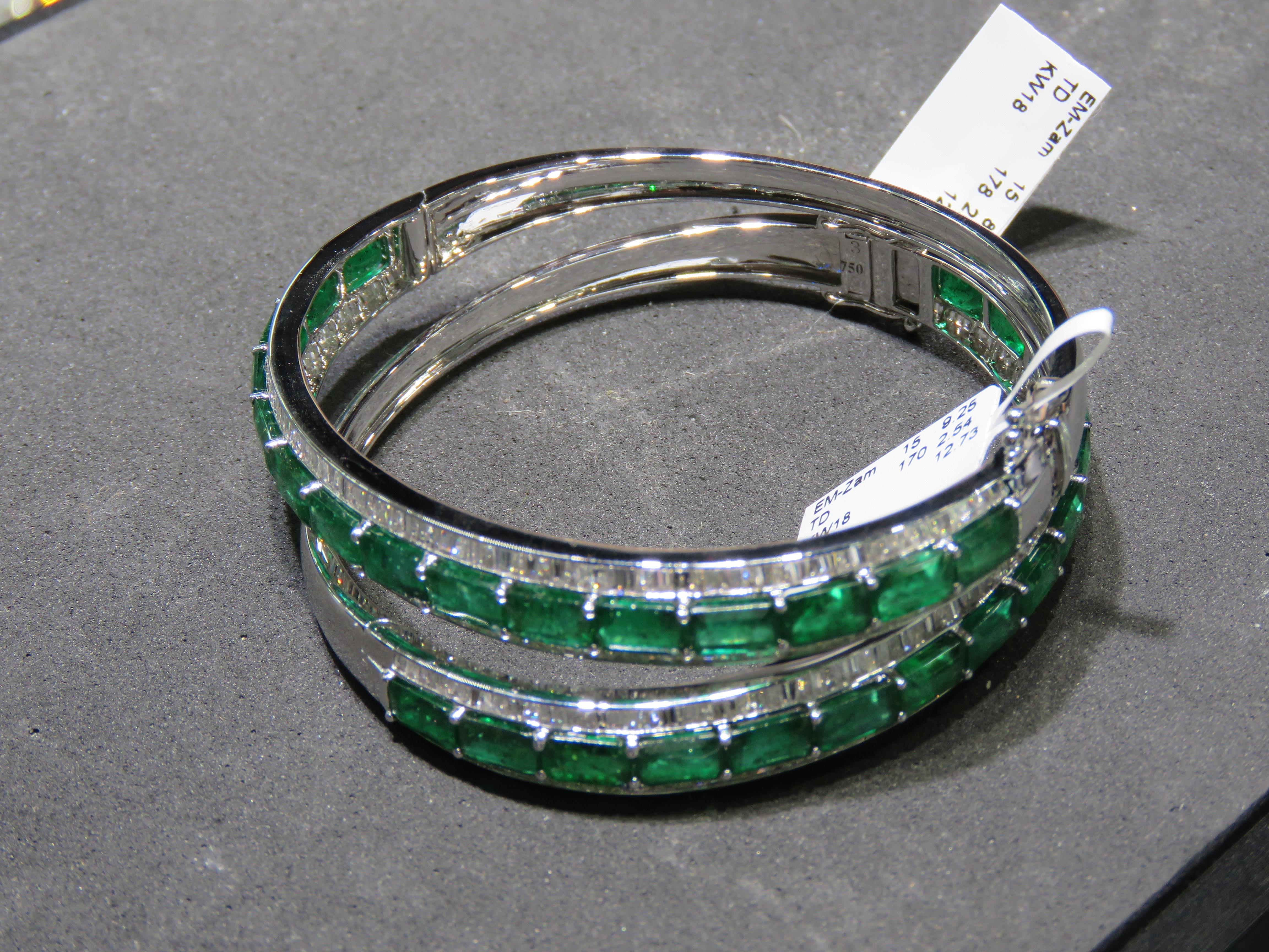 The Following Item we are offering is a Pair of Rare Magnificent Radiant 18KT Gold Large Rare Gorgeous Fancy Emerald and Diamond Bangle Cuff Bracelets. Bracelets are comprised of Beautiful Glittering Emeralds Framed with Gorgeous Glittering