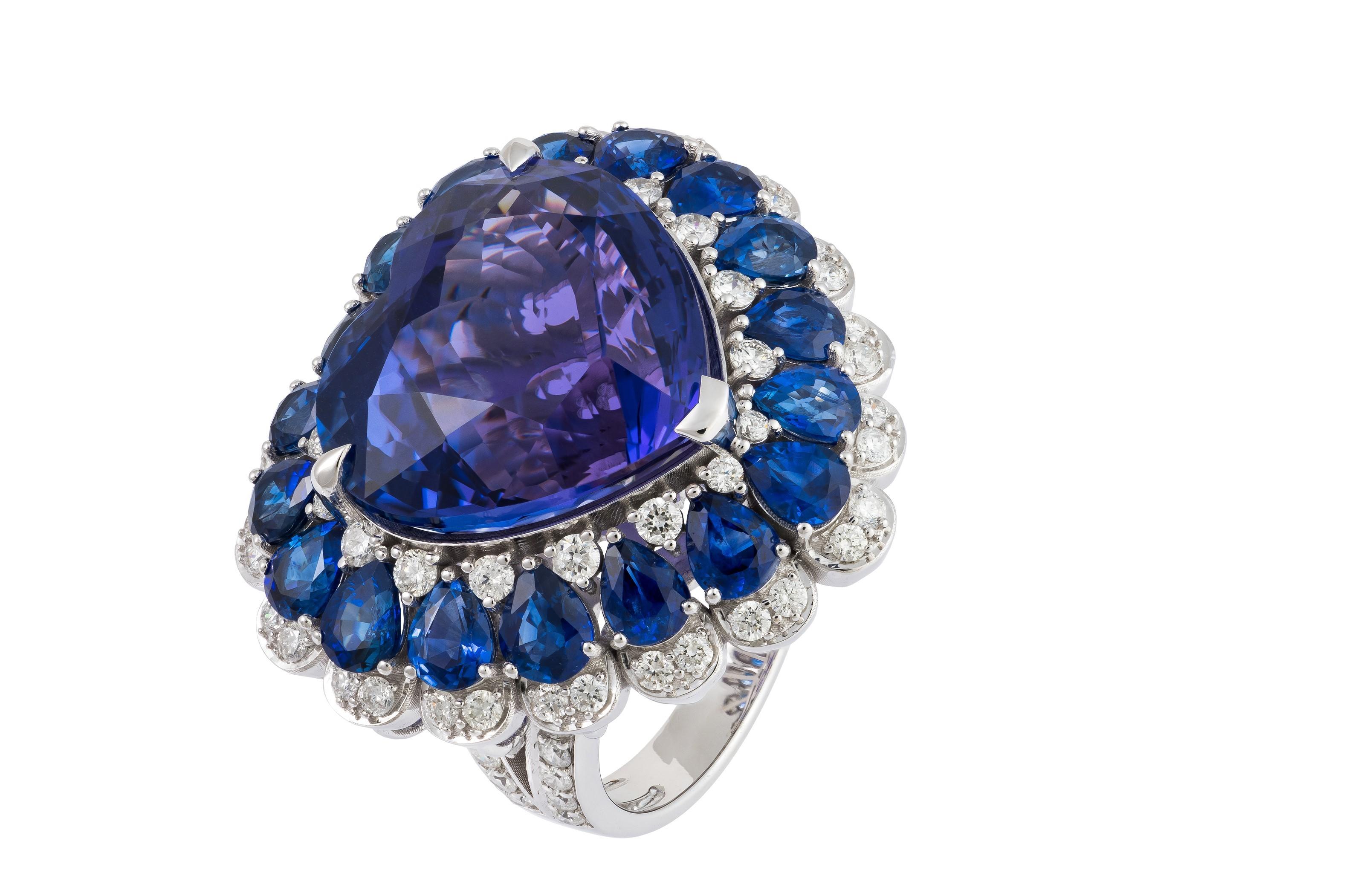 The Following Item we are offering is a Rare Important Spectacular and Brilliant 18KT Gold Large Gorgeous Tanzanite Heart Sapphire Diamond Ring. Ring consists of a Rare Fine Magnificent Rare Tanzanite Heart surrounded with a Gorgeous Halo of Blue