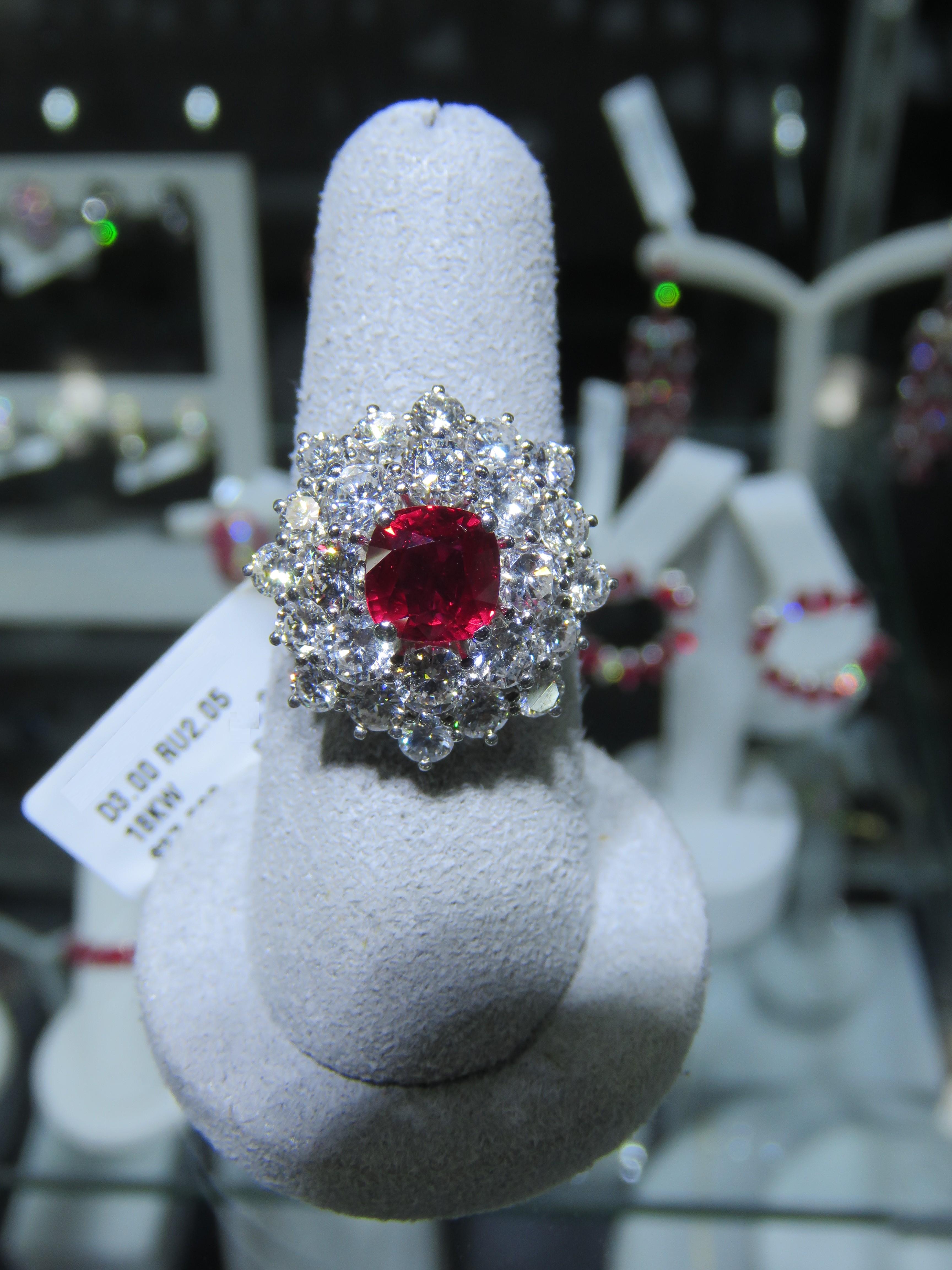 The Following Item we are offering is a Rare Important Radiant 18KT Gold Large Ruby Diamond Ring. Ring is comprised of A Gorgeous Fancy Deep Pigeon Blood Ruby surrounded with Exquisite Glittering Fancy Double Halo of Large Round  Diamonds. T.C.W