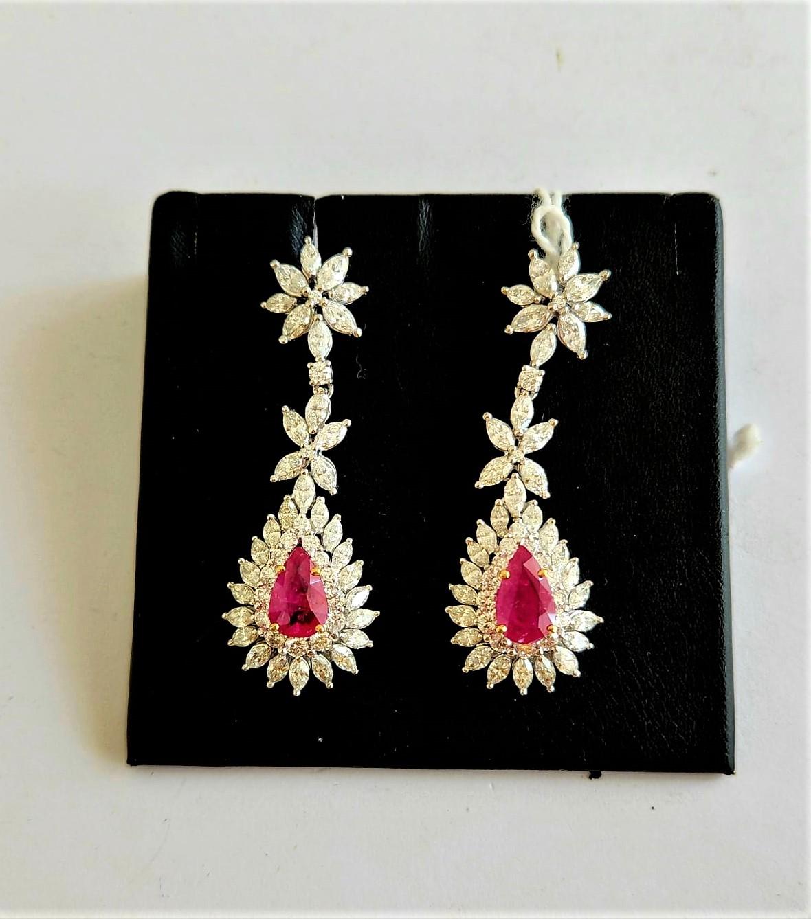 The Following Item we are offering is this Rare Important Radiant 18KT Gold Gorgeous Glittering and Sparkling Magnificent Fancy Ruby and Diamond Dangle Earrings. Earrings contain approx 11CTS of Beautiful Rare Fancy Rubies and Diamonds!!! Stones are