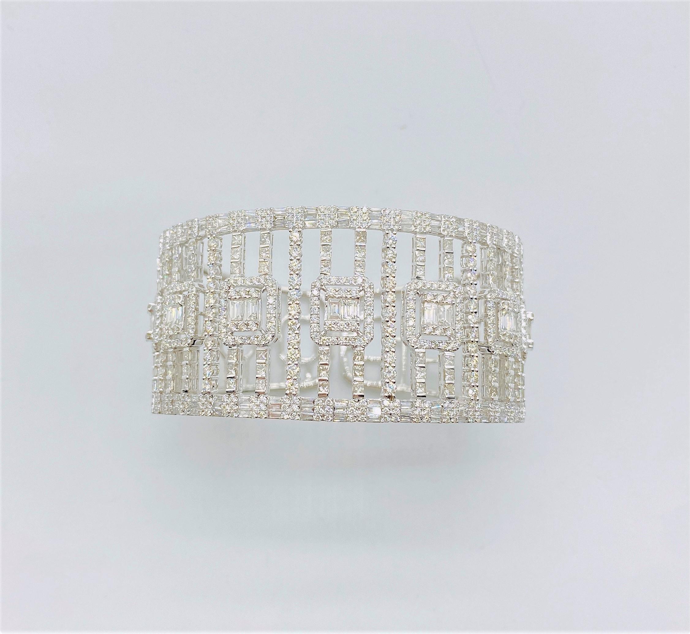 The Following Item we are offering is this Extremely Rare Beautiful 18KT Gold Fine Fancy Rare Large Wide Diamond Bangle Bracelet. This Magnificent Bangle is comprised of Rare Fine Large Trillion Baguette Diamonds and Round Gorgeous Glittering Fancy