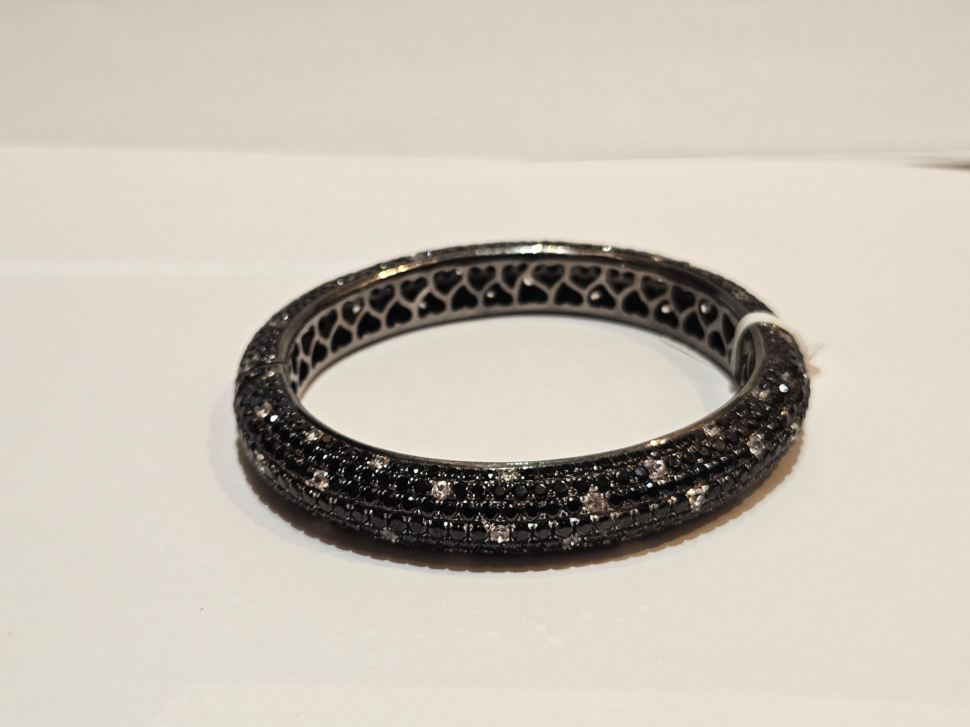 The Following Item we are offering is this Rare Magnificent FANCY BLACK SPINEL WHITE SAPPHIRE STERLING SILVER CUFF BANGLE BRACELET. T.C.W. OVER 26CTS!!! This Magnificent Bangle is a Rare Sample Piece that were sold in select Five Star Hotels and