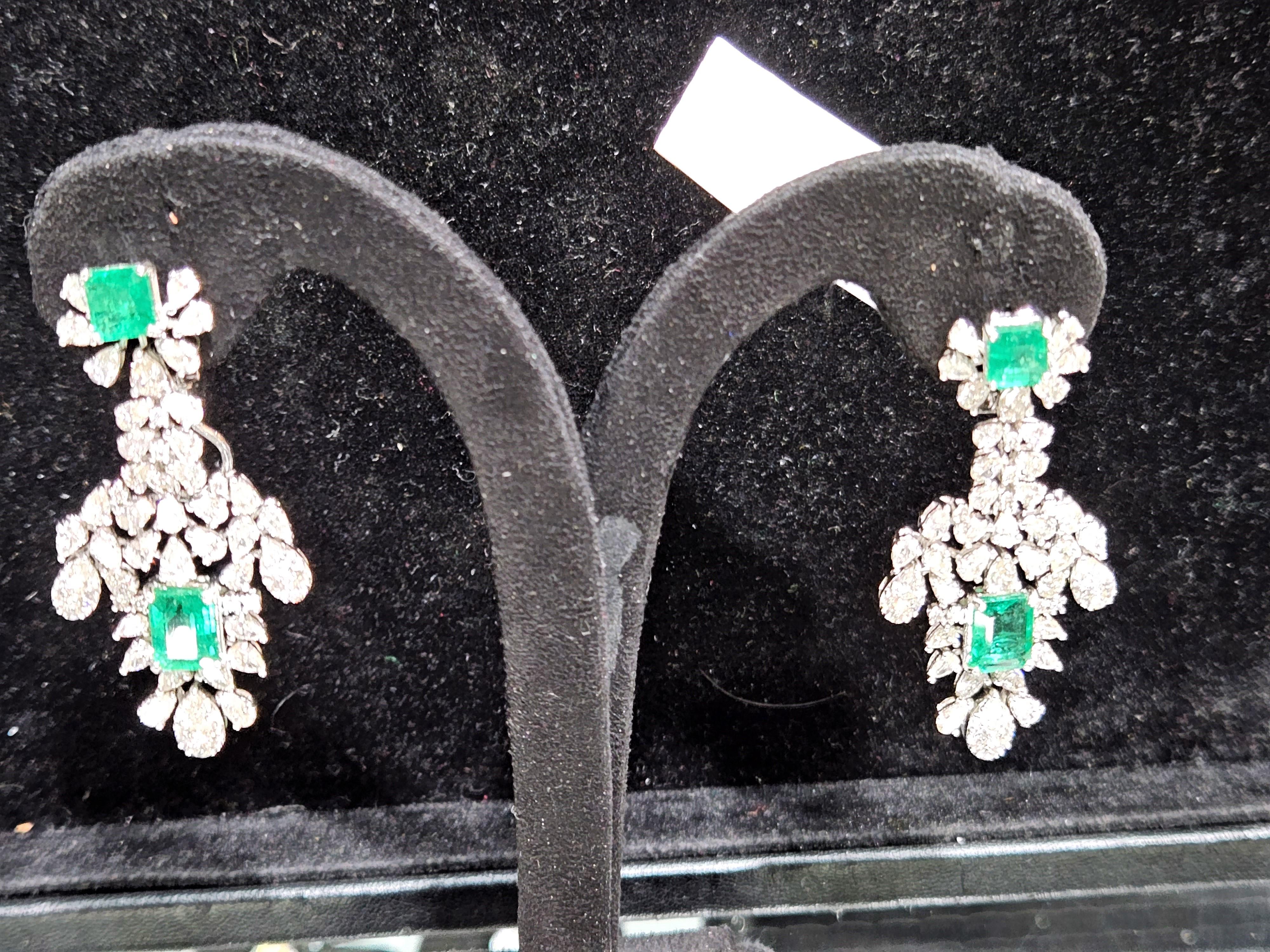 The Following Item we are offering is this Rare Important Radiant White Gold Gorgeous Glittering and Sparkling Magnificent Fancy Emerald and Baguette Diamond Dangle Earrings. Earrings contain approx 13CTS of Beautiful Rare Fancy Emeralds and