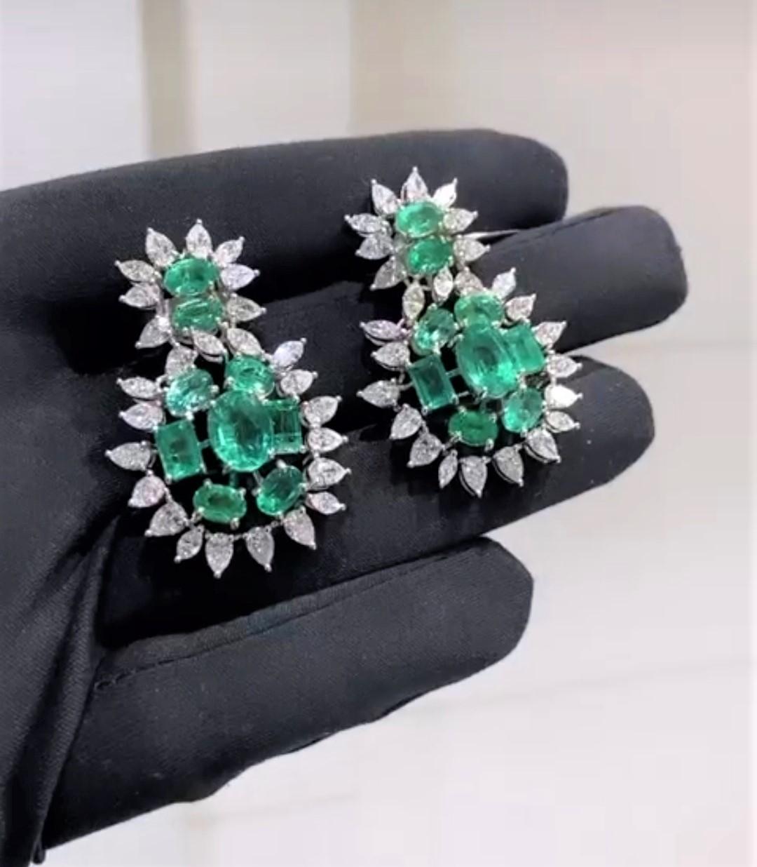 The Following Items we are offering is a Pair of Rare 18KT Gold Large Emerald Diamond Dangle Earrings. Earrings are comprised of Finely Set Gorgeous Large Gorgeous Green Emerald Diamond Earrings surrounded with Large Full Cut Fancy Marquise and Pear