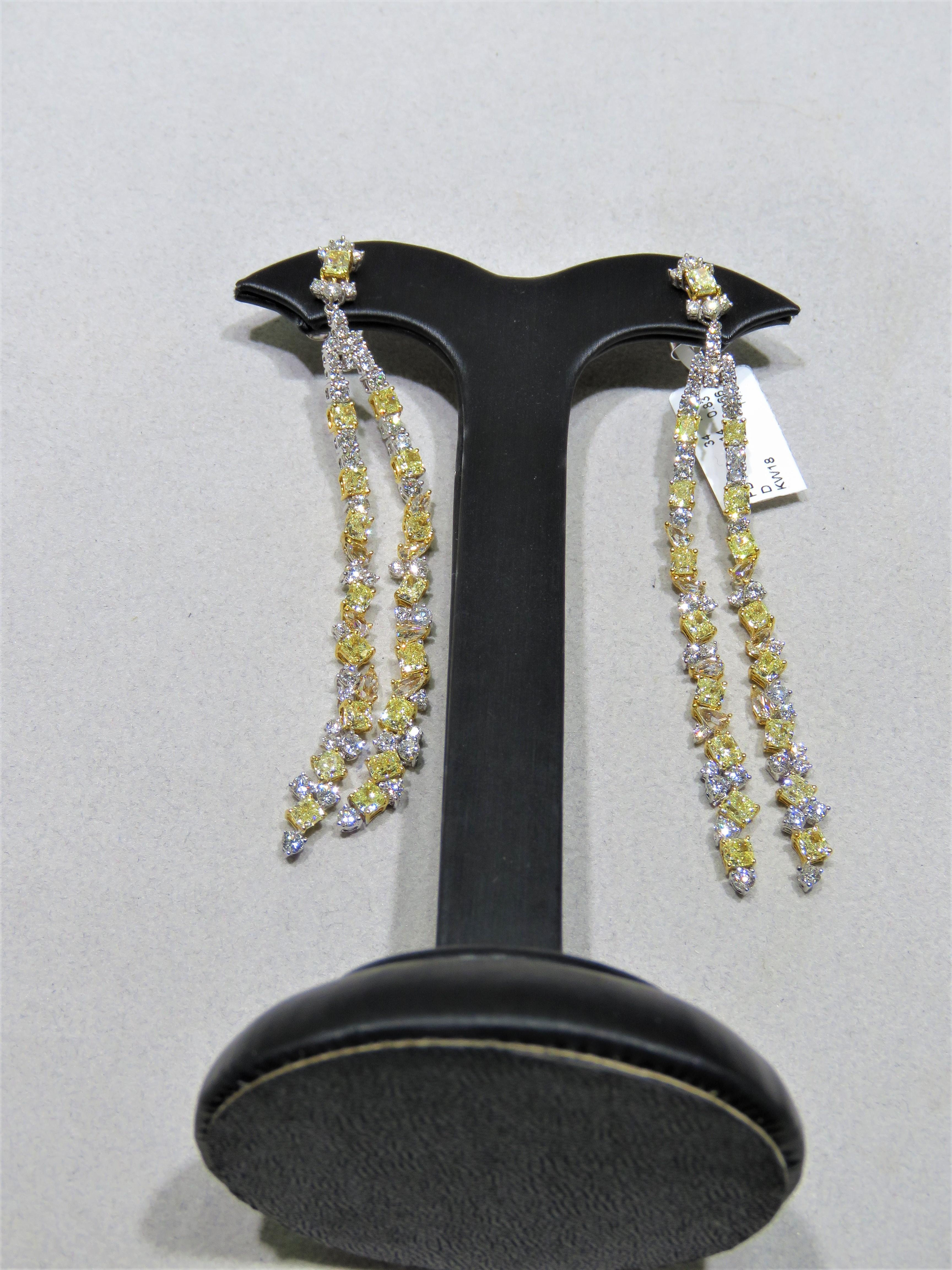 The Following Item we are offering are these Extremely Rare Beautiful 18KT Gold Fine Large Fancy Yellow and White Diamond Dangle Earrings. Each Earring features Rare Gorgeous Glittering Fancy Large Yellow Diamonds adorned with Sparkling Mixed White