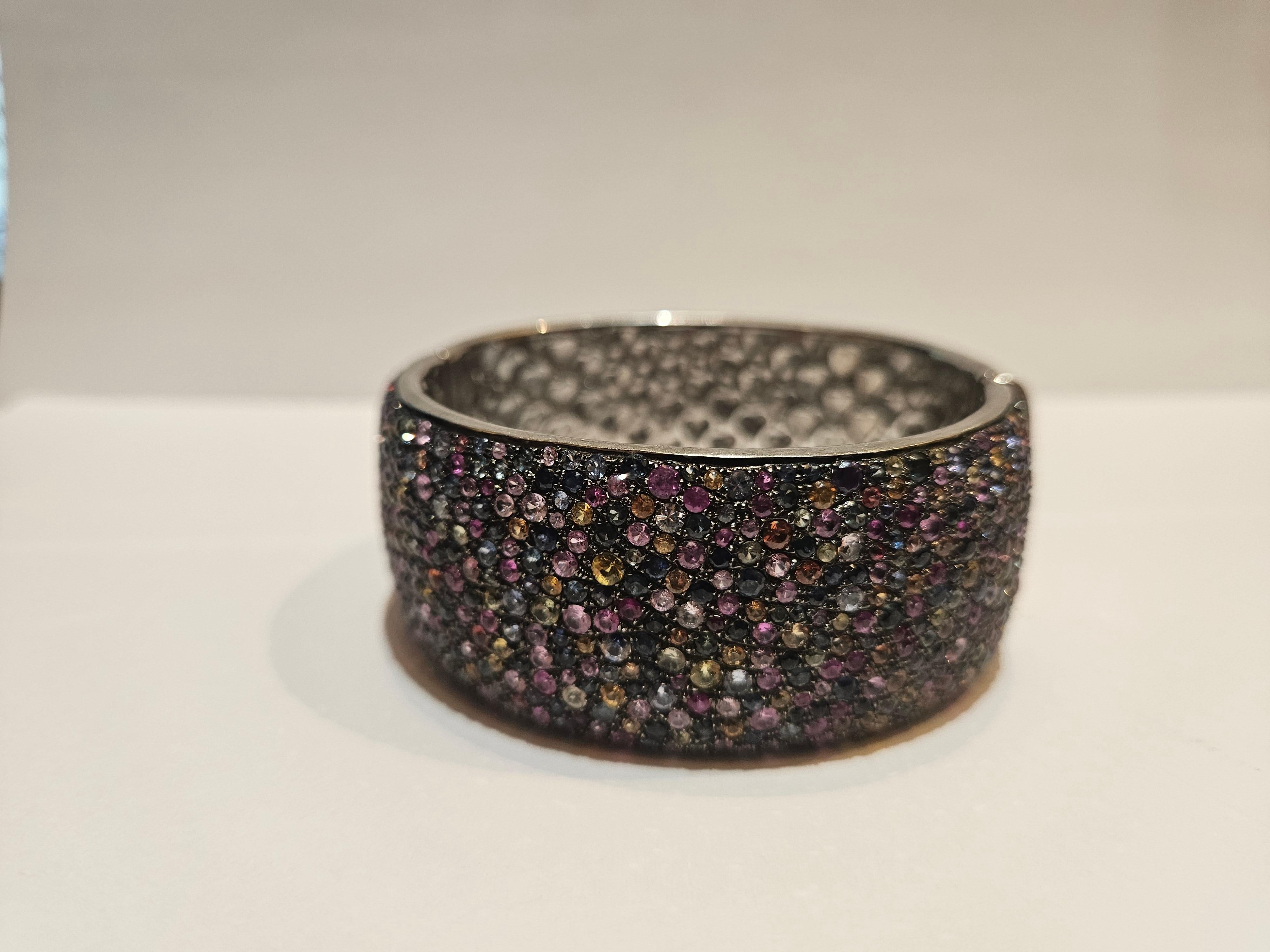 The Following Item we are offering is this Rare Magnificent FANCY RAINBOW SAPPHIRE STERLING SILVER CUFF BANGLE BRACELET WITH APPROX 27CTS OF RAINBOW SAPPHIRES!!! This Magnificent Bangle is a Rare Sample Piece that were sold in select Five Star