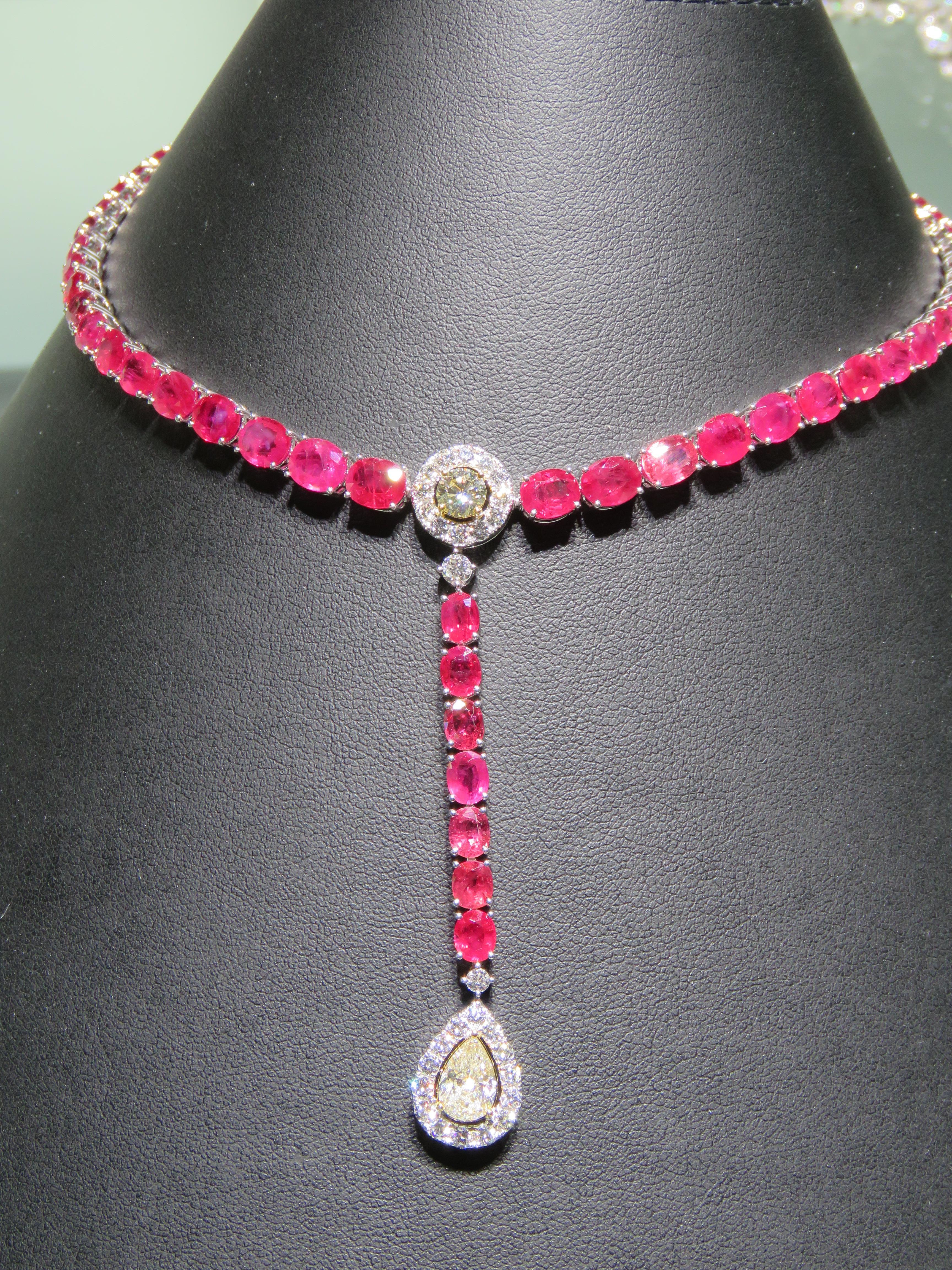 The Following Item we are offering is this Rare Important Radiant 18KT Gold Gorgeous Glittering and Sparkling Magnificent Fancy Ruby and Diamond Drop Necklace. Necklace contains approx 35CTS of a Beautiful Fancy Rubies surrounded with Fancy