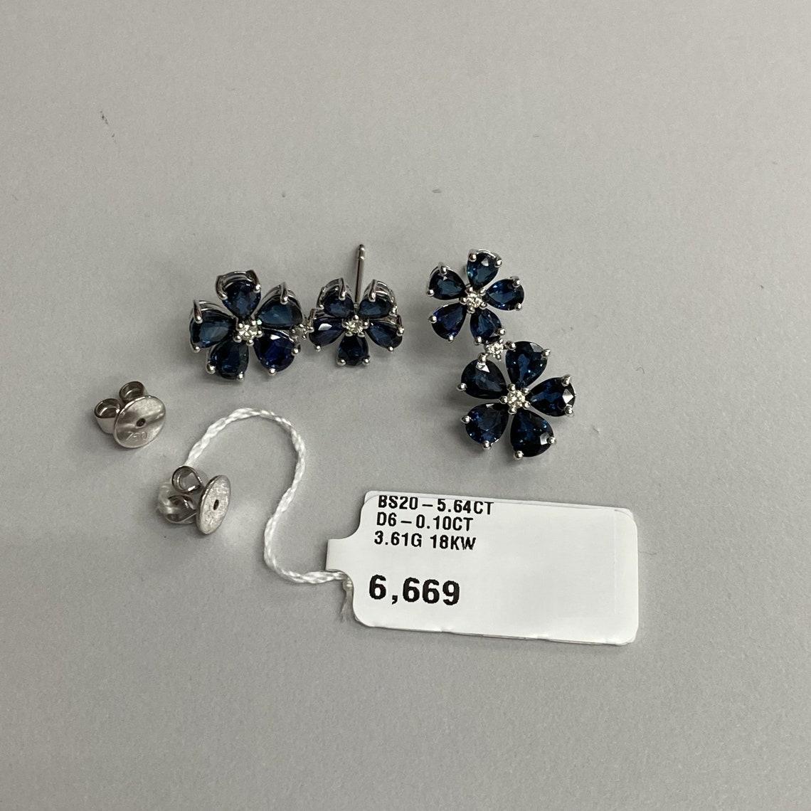 A Rare Important Pair of 18KT White Gold Large Blue Sapphire and Diamond Floral Flower Dangle Earrings. Earrings are comprised of approx 6 Carats of Finely Set Glittering Sapphires and Diamonds forming Flowers. The Sapphires and Diamonds are of