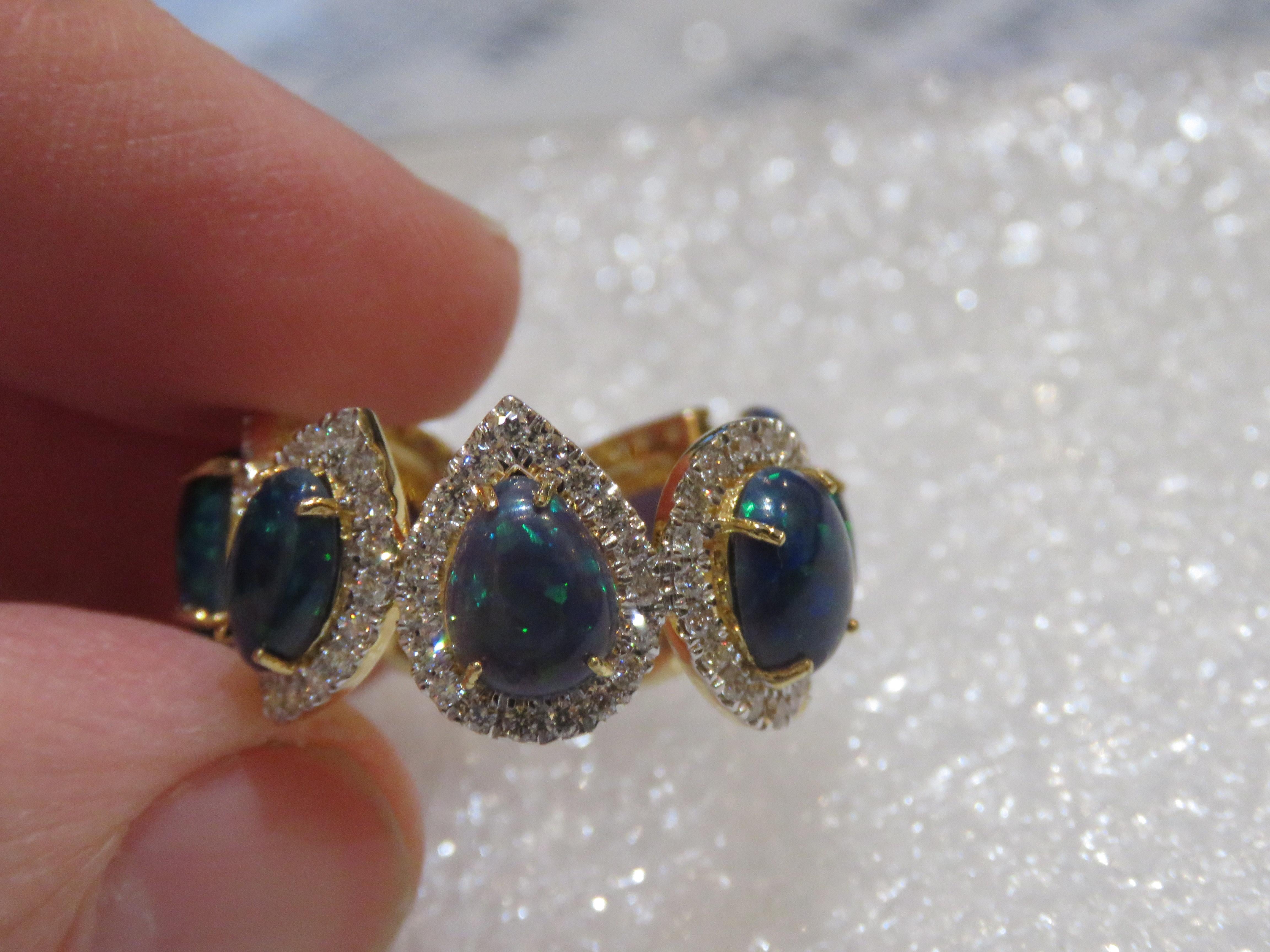 The Following Items we are offering is a Rare Important Spectacular and Brilliant 18KT Gold Large Gorgeous Black Opal Diamond Ring. Ring consists of Rare Fine Magnificent Opals surrounded and Framed and Surrounded by a Halo of Beautiful Glittering