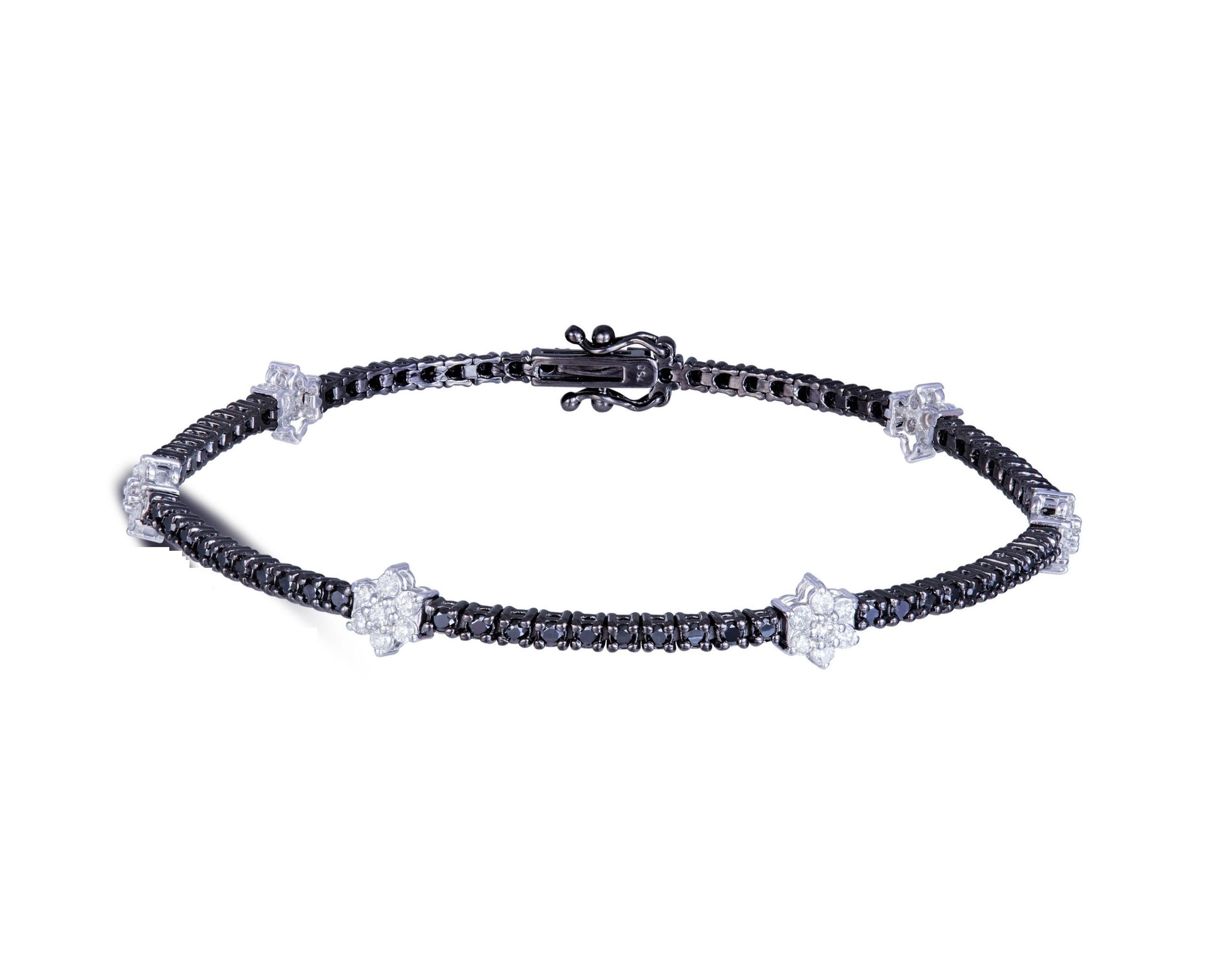 The Following Item we are offering is a Important Radiant 18KT Gold Rare Fancy Gorgeous Black Diamond White Diamond Tennis Bracelet. Bracelet is comprised of Fancy Black Diamonds interlocking with Large White Floral Diamond Clusters. T.C.W. Approx