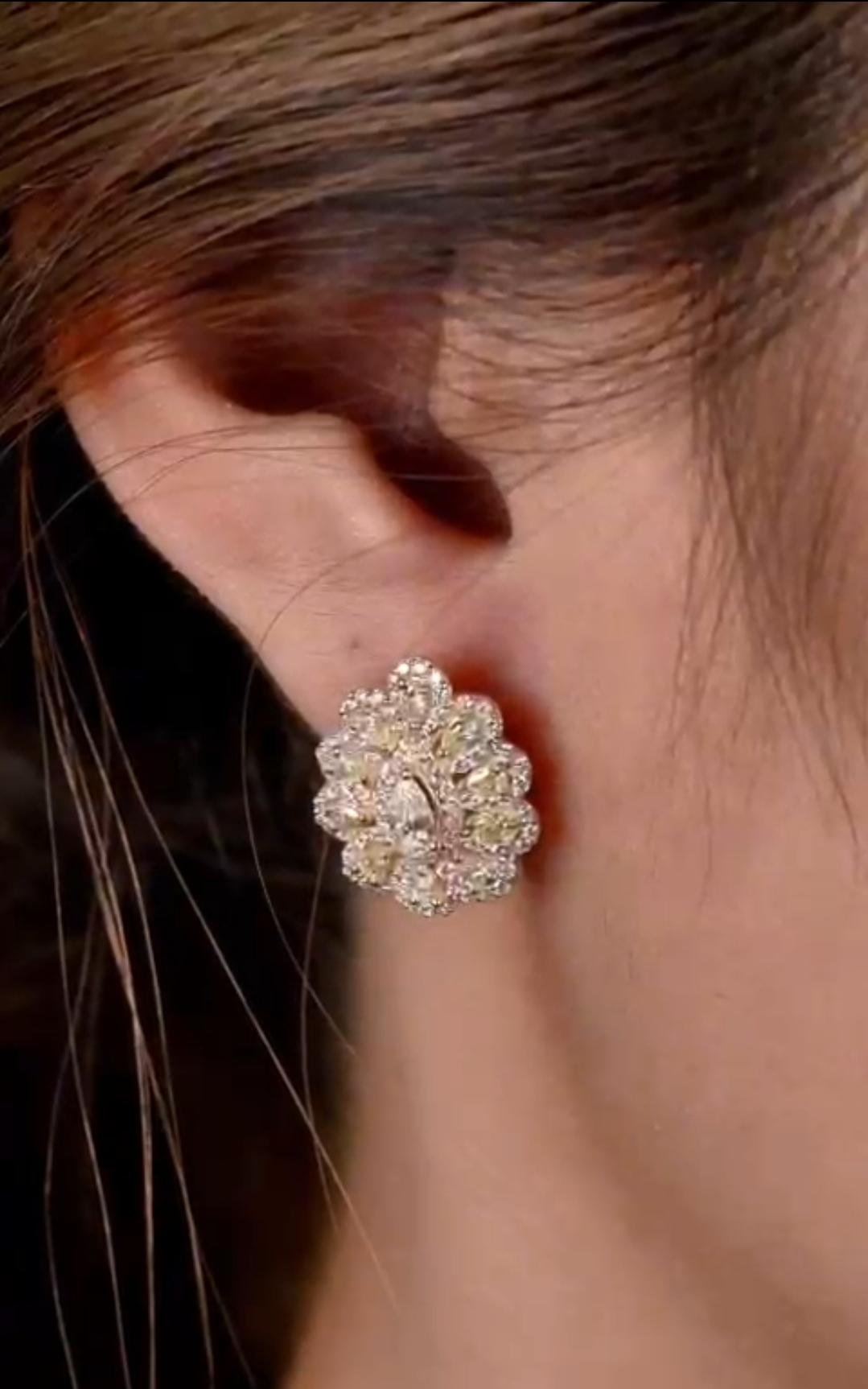 The Following Item we are offering is this Rare Important Radiant 18KT Gold Gorgeous Glittering and Sparkling Magnificent Fancy Yellow Diamond Earrings. Earrings Contains approx 1.50CTS of Beautiful Fancy Yellow Diamonds framed with White