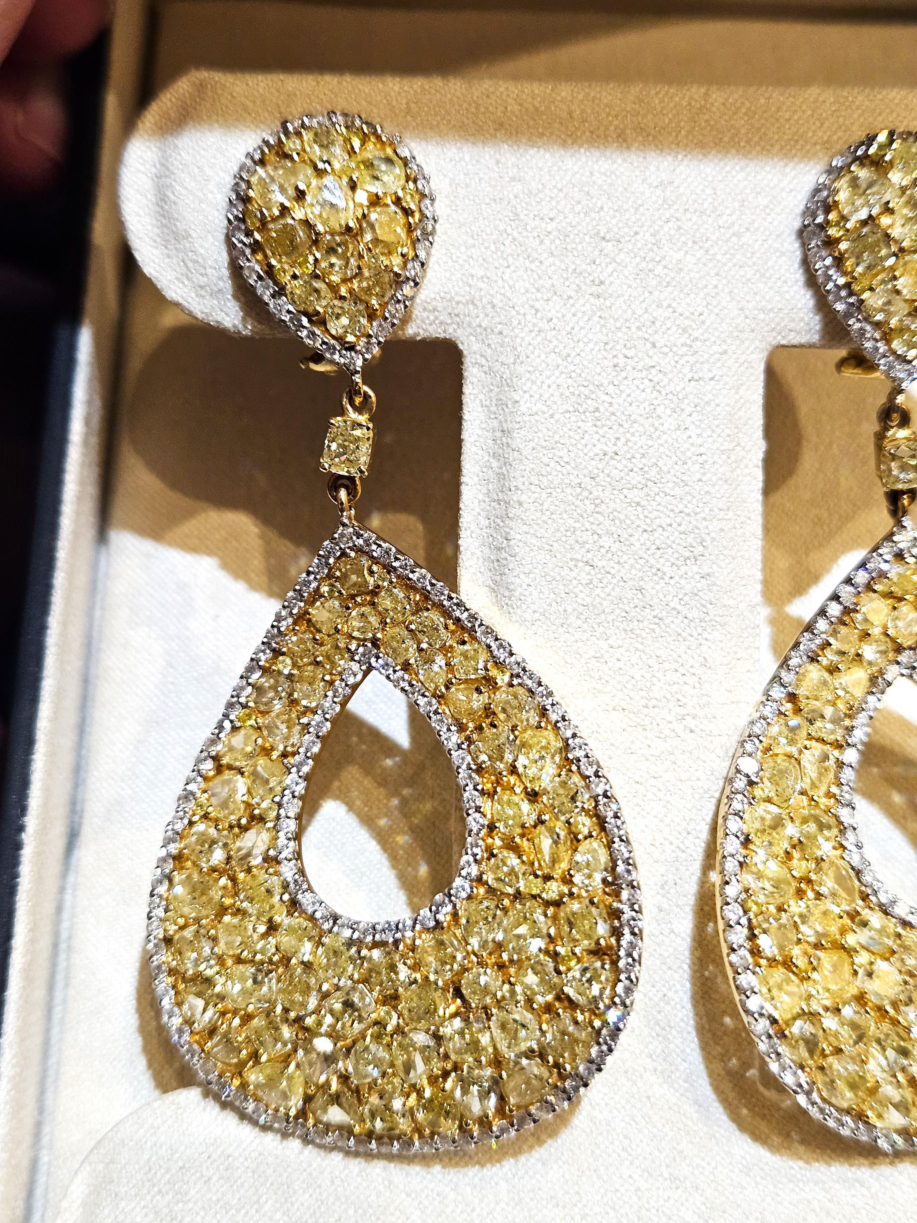 The Following Item we are offering are these Extremely Rare Beautiful 18KT Gold Fine Large Fancy Yellow and White Diamond Dangle Earrings. Each Earring features Rare Gorgeous Glittering Fancy Yellow Diamonds Draped with Sparkling White Diamonds in