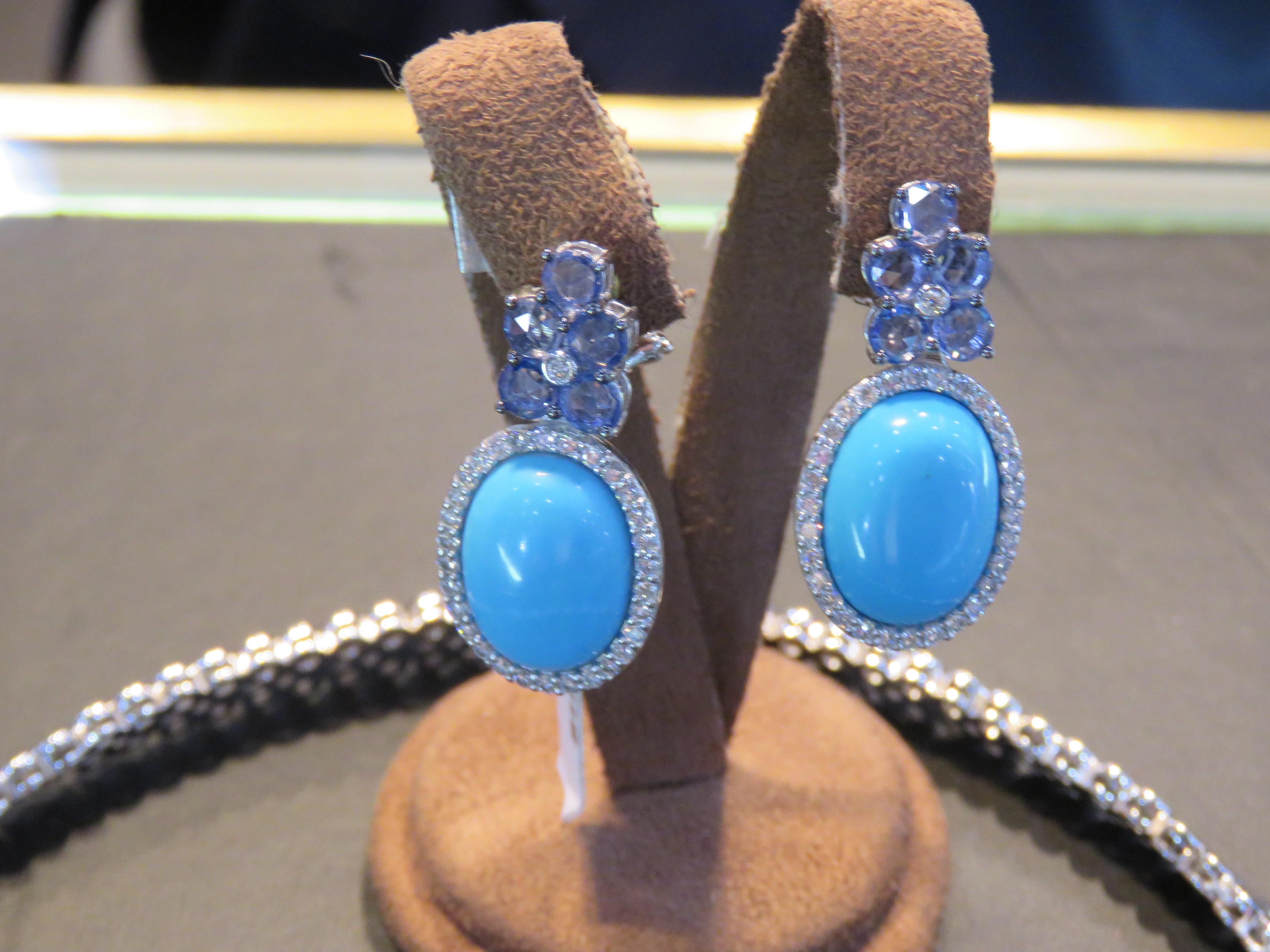 The Following Items we are offering is a Pair of Rare 18KT Gold Large Turquoise Diamond Blue Sapphire Dangle Earrings. Earrings are comprised of Finely Set Gorgeous Large Oval Gorgeous Turquoise Framed with Magnificent Glittering Diamonds Earrings.