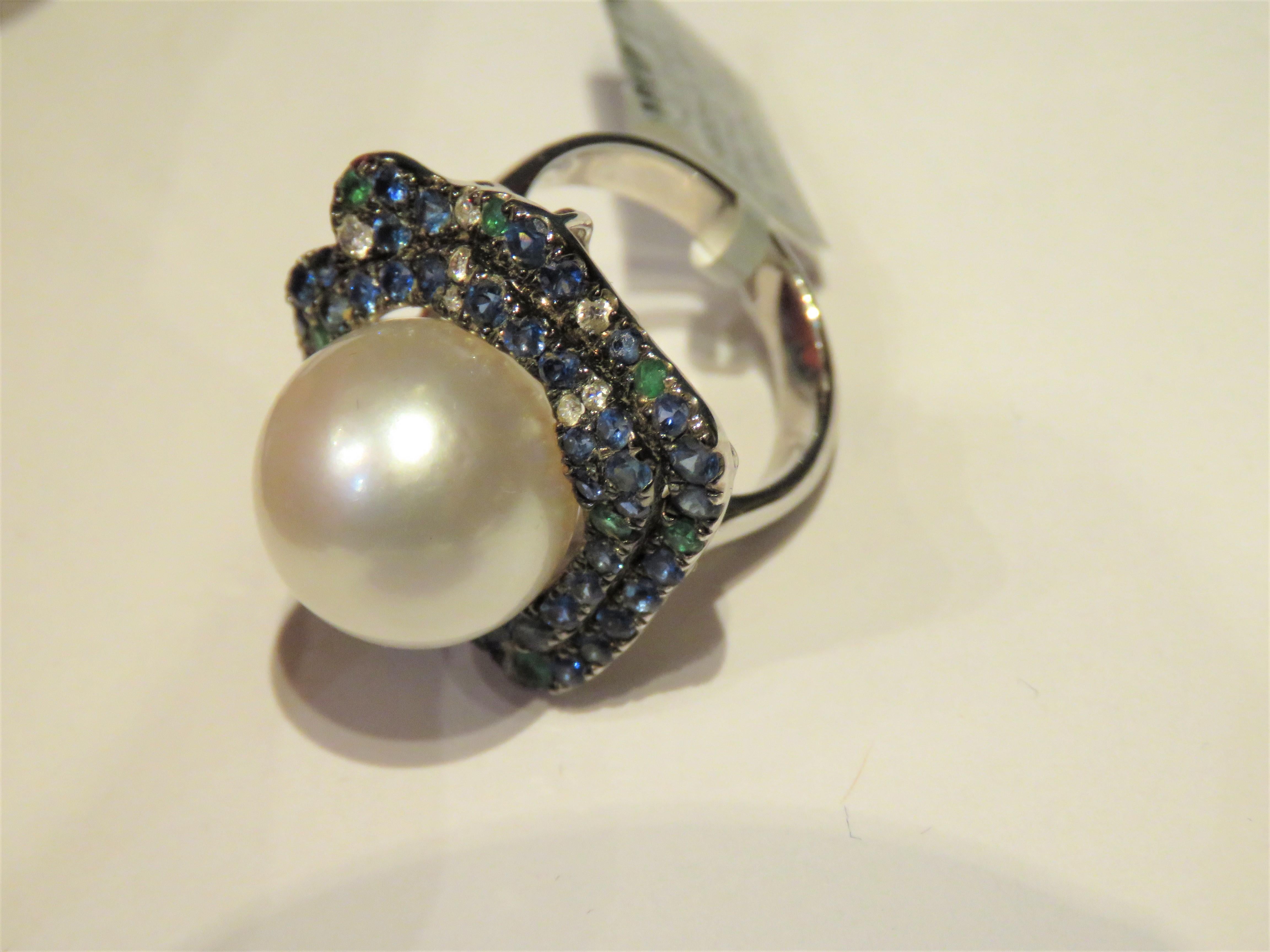 The Following Item we are offering is this Extremely Rare Beautiful 18KT Gold Fine Rare Large South Sea Pearl Fancy Diamond Ring. This Magnificent Ring is comprised of a Rare Fine 13MM-14MM Large South Sea Pearl and Round Gorgeous Glittering Blue