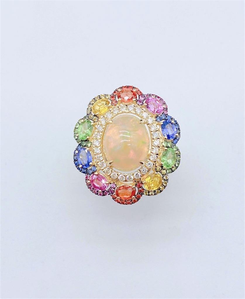 The Following Item we are offering is a Rare Important Radiant 18KT Gold Large Fancy Fiery White Opal Diamond Multi Sapphire Ring. Ring is comprised of A LARGE Gorgeous Fancy Fiery White Rainbow Opal surrounded by Beautiful Glittering Diamonds and