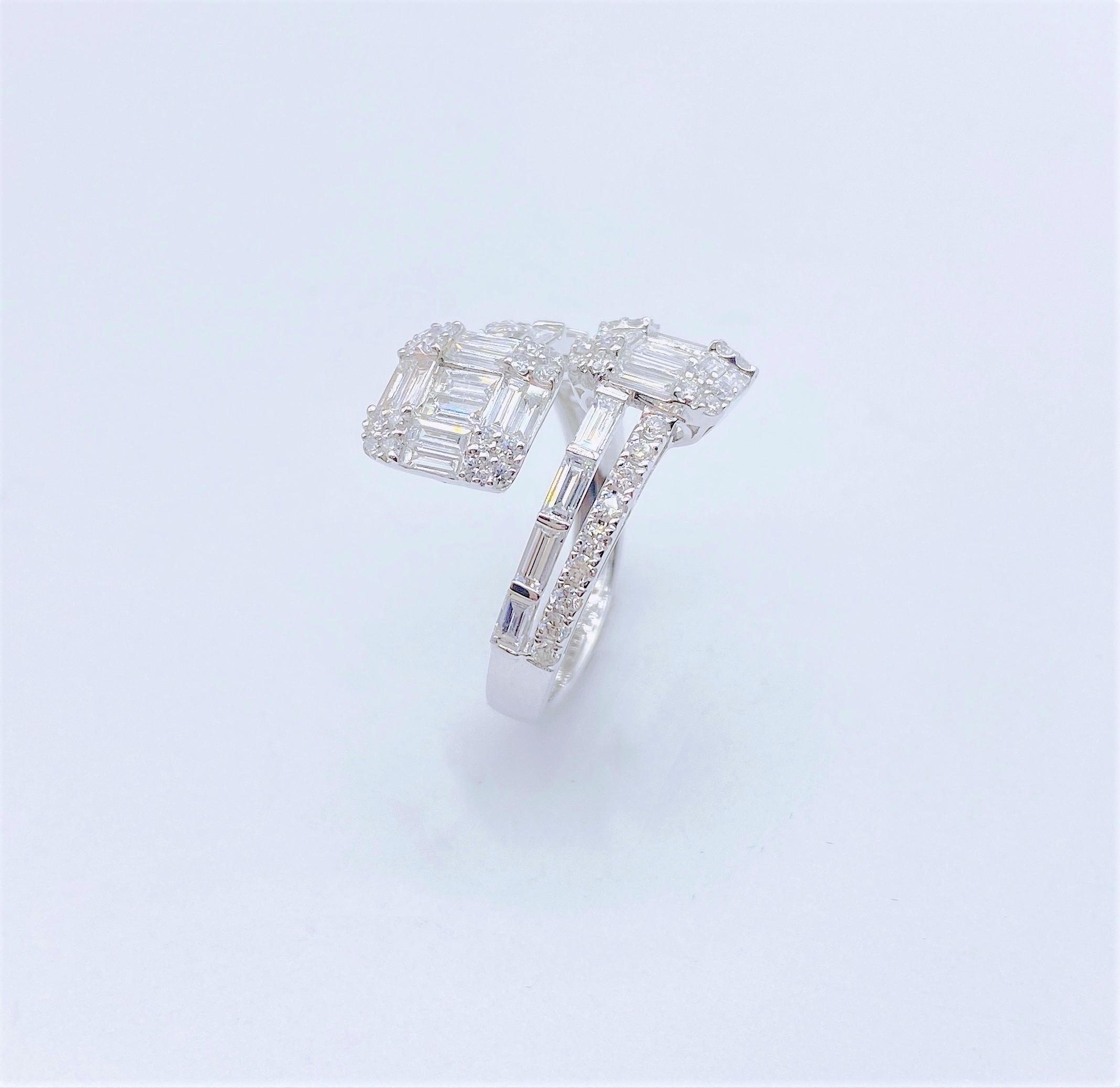 The Following Item we are offering is this Beautiful Rare Important 18KT White Gold Glittering Diamond Crossver Ring. Ring is comprised of Approx 1.50CTS of Magnificent Rare Gorgeous Fancy Trillion Baguette Cut Diamonds with Round Glittering