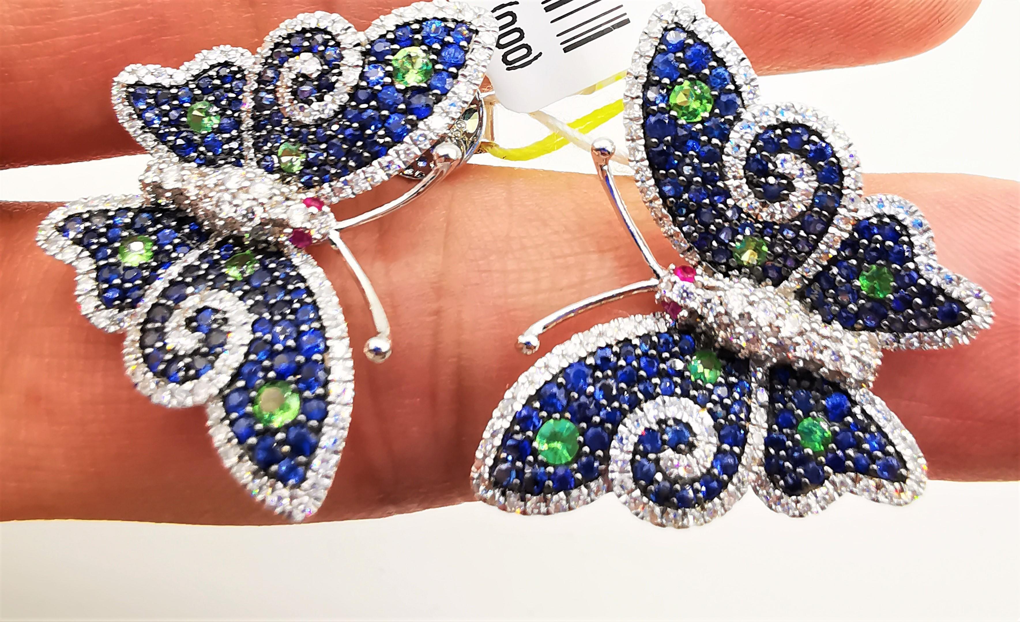 
The Following Items we are offering is a Rare Important Radiant 18KT Yellow Gold and 18KT Gold Gorgeous Glittering Blue Sapphire and Tsavorite Butterfly Diamond Earrings. Earrings Feature Gorgeous Colorful Blue Sapphires adorned with Spectacular