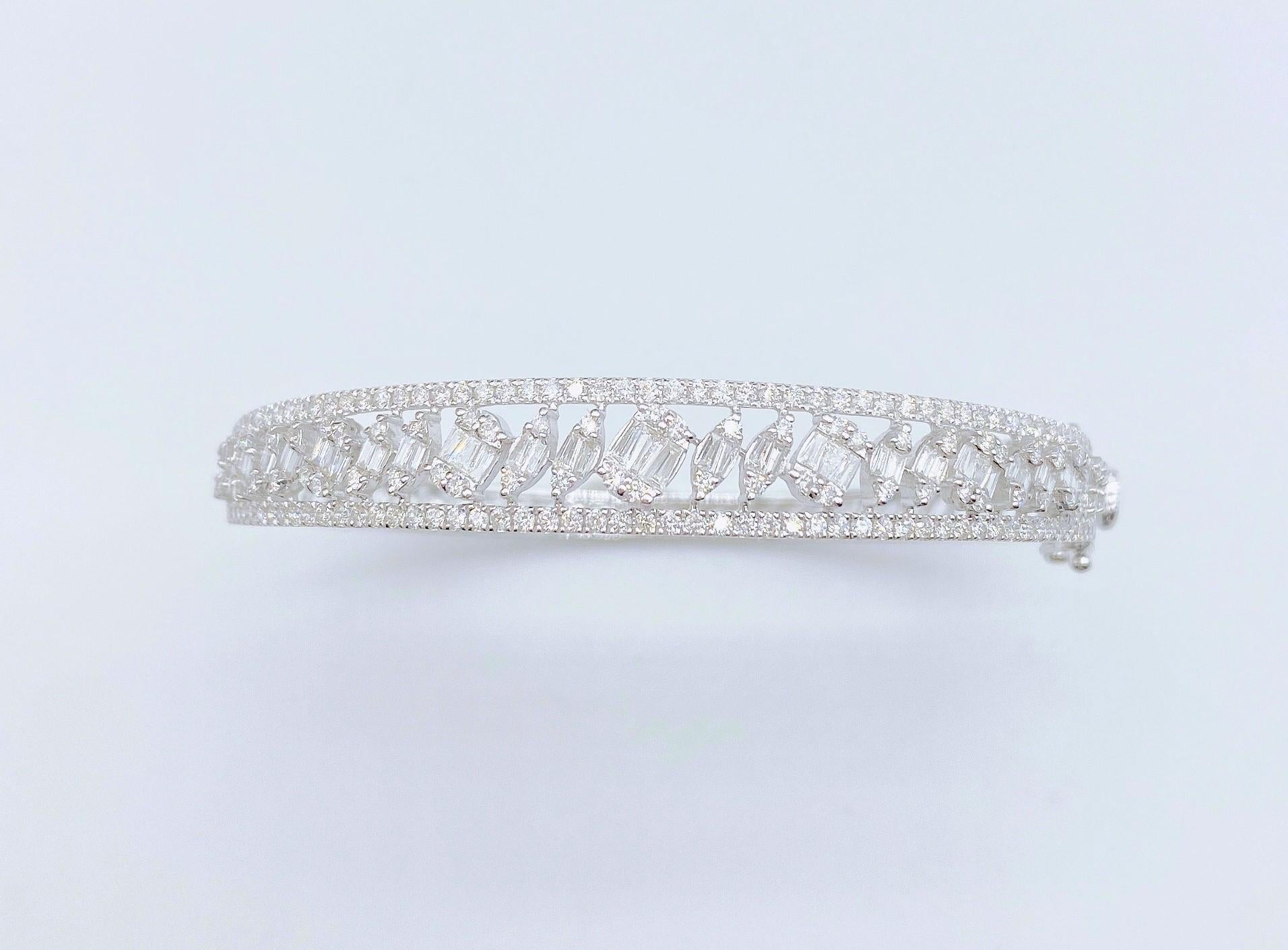 The Following Item we are offering is this Beautiful Rare Important 18KT White Gold Glittering Diamond Bangle Bracelet. Bracelet is comprised of Approx 2.00CTS of Magnificent Rare Gorgeous Fancy Trillion Cut Diamonds with Round Glittering
