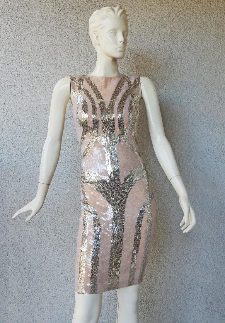 Alexander Mcqueen 2009 hand beaded evening dress. Form fitting and tastefully fashioned of nude silk showered with clear sequins overlaid in a geometric pattern of silver sequins. Boasts an interior corset creating a streamline silhouette. In