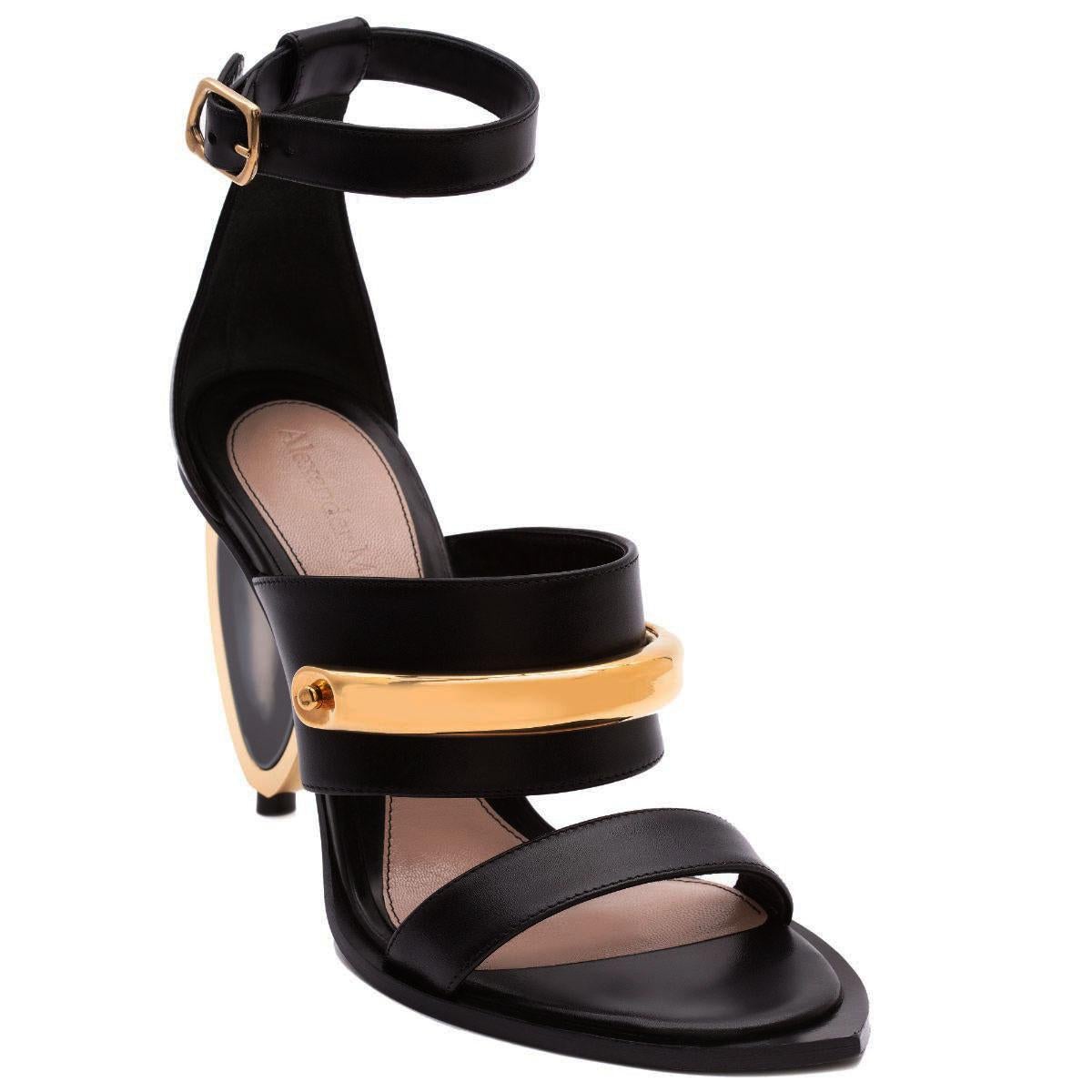 New Alexander McQueen Black Leather Gold Detail Shoes Sandals
P/F 2020 Collection
Italian size 36 - US 6
The Sandal Featuring a Stone-like Resin Heel and a Gold-Finished Metal Cuff Bar.
Heel Height - 3.5 inches, Padded Leather Insole, Leather