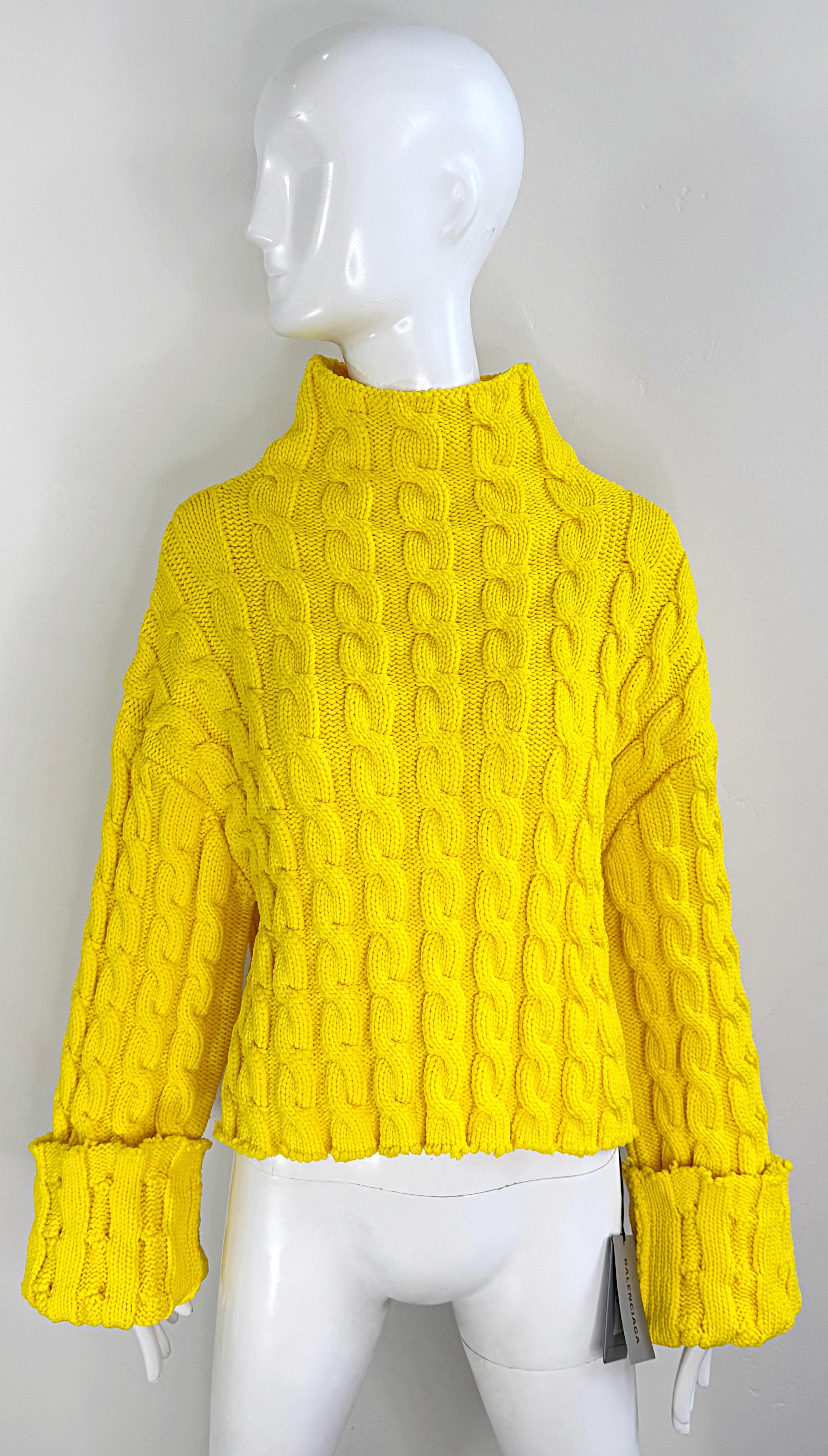 Make a statement in this brand new with tags Balenciaga bright yellow slightly cropped cable knit sweater ! Features soft polypropylene (99%) and polyamide (1%) fabric that stretches to fit. Raw edges, with extra long sleeves that can be cuffed.