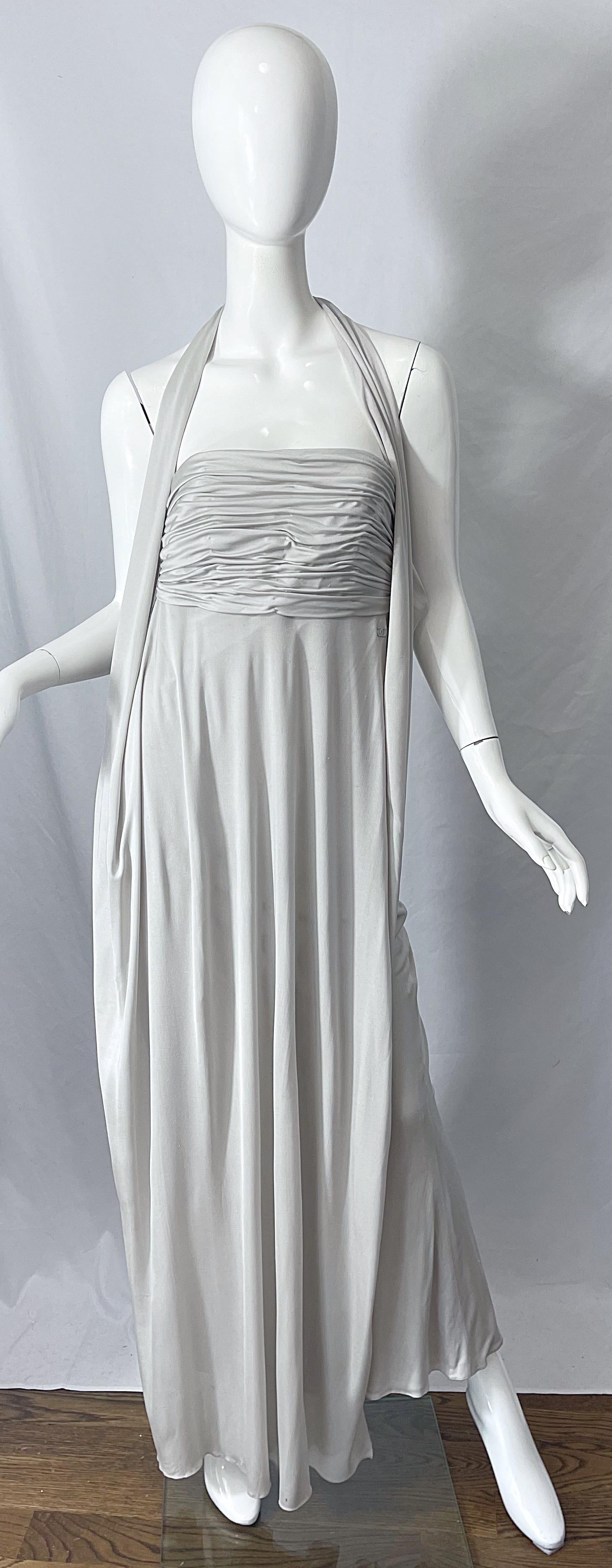 Beautiful vintage new w/ tags CHANEL Cruise 2004 by KARL LAGERFELD Cruise silk jersey gray halter gown ! Features a ruched bodice with CC logo at right waist. Sexy open back reveals just the right amount of skin. Hidden hook-and-eye closures at back