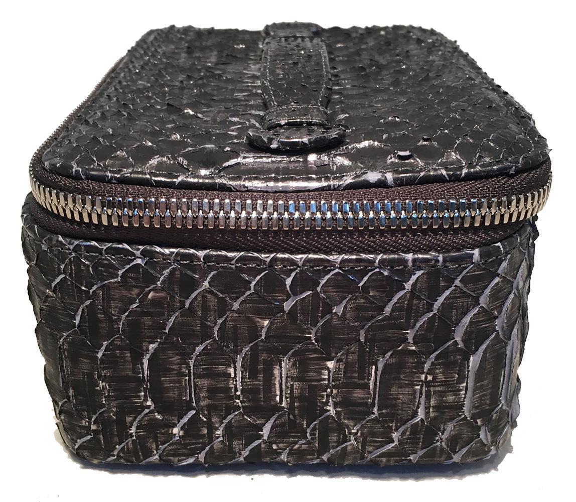 NWT Chanel Gray Python Snakeskin Jewelry Travel Pouch Case with Accessories in new condition. Grey metallic snakeskin python exterior trimmed with a silver double zip closure and top handle. Interior lined in black microsuede and includes a black