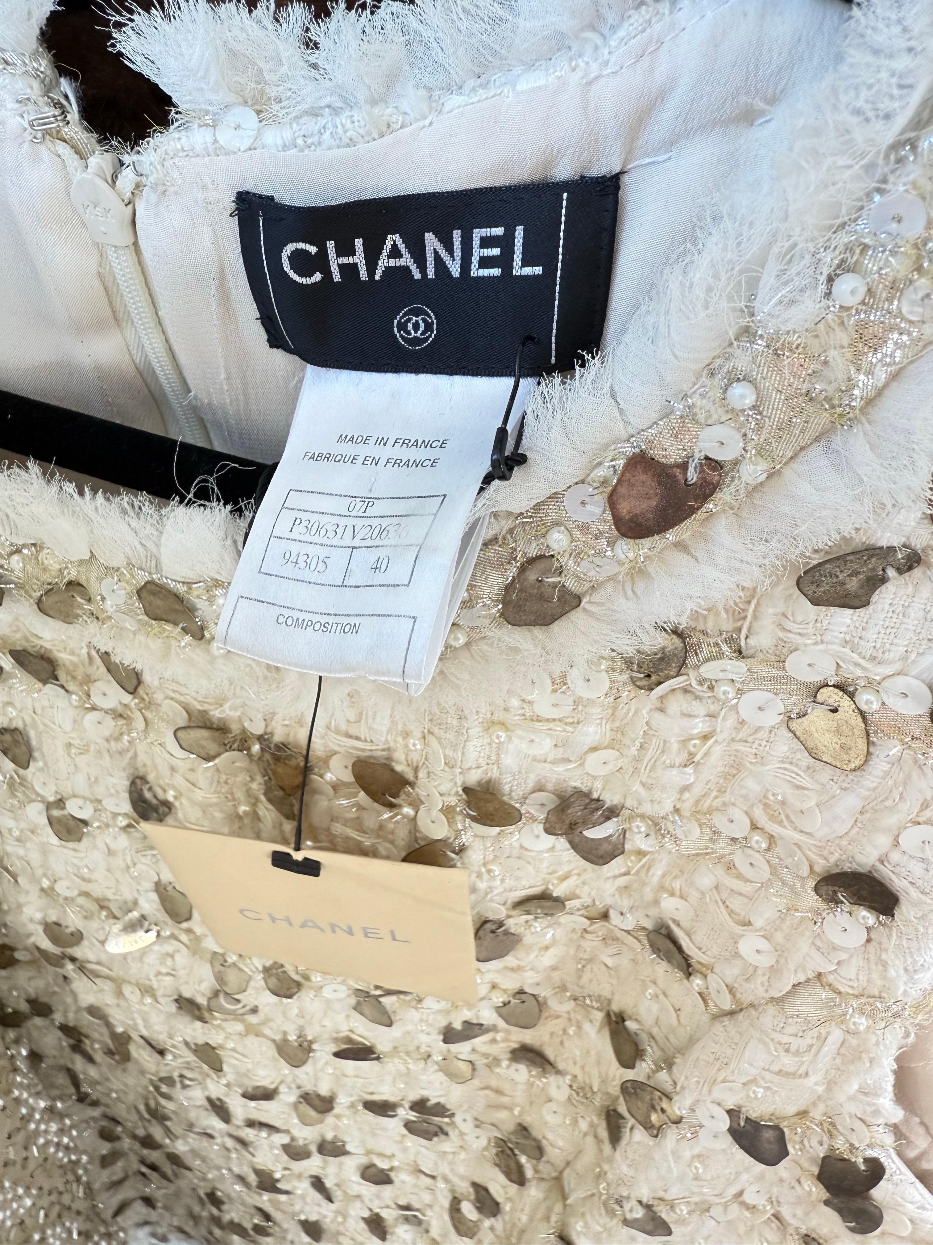 Brand new with tags Chanel, by Karl Lagerfeld Spring 2007 ivory sequin and pearl encrusted sleeveless dress ! Features intricate weaving technique with 62% Cotton, 19% Acrylic, 19% Polyester. Rhinestone CC emblem at left side waist. Hundreds of