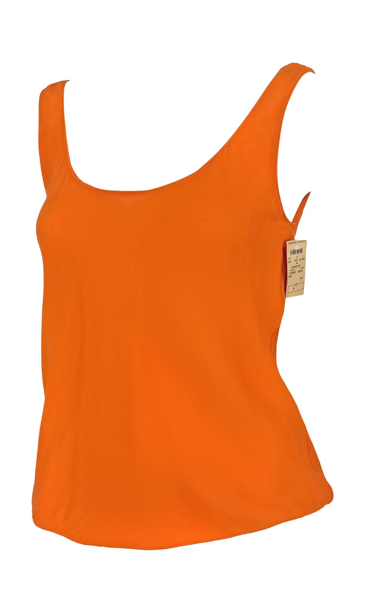 This new-with-tags bright orange tank top from the early 1990s by Donna Karan is crafted from lightweight sheer silk. Designed with a clean scoop neckline and a fluid, draped fit.

Approximate measurements:
Size - Petite
Bust: 34