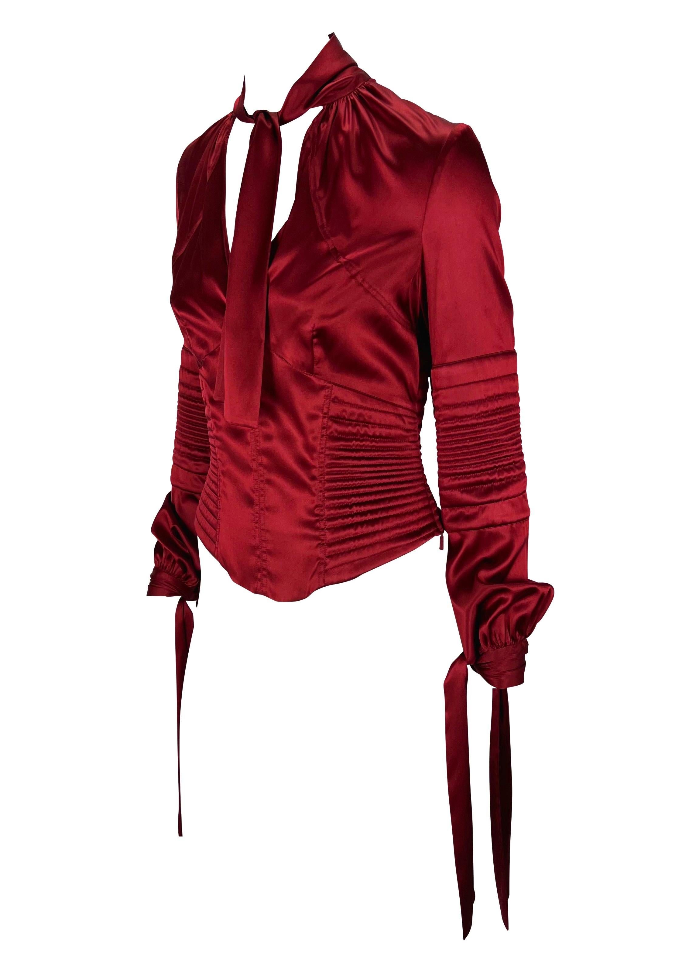 Presenting a vibrant red silk satin Gucci blouse designed by Tom Ford. From the Fall/Winter 2003 collection, this beautiful top features quilted details on the body creating a corset silhouette. With a deep neckline, this top has ties that wrap