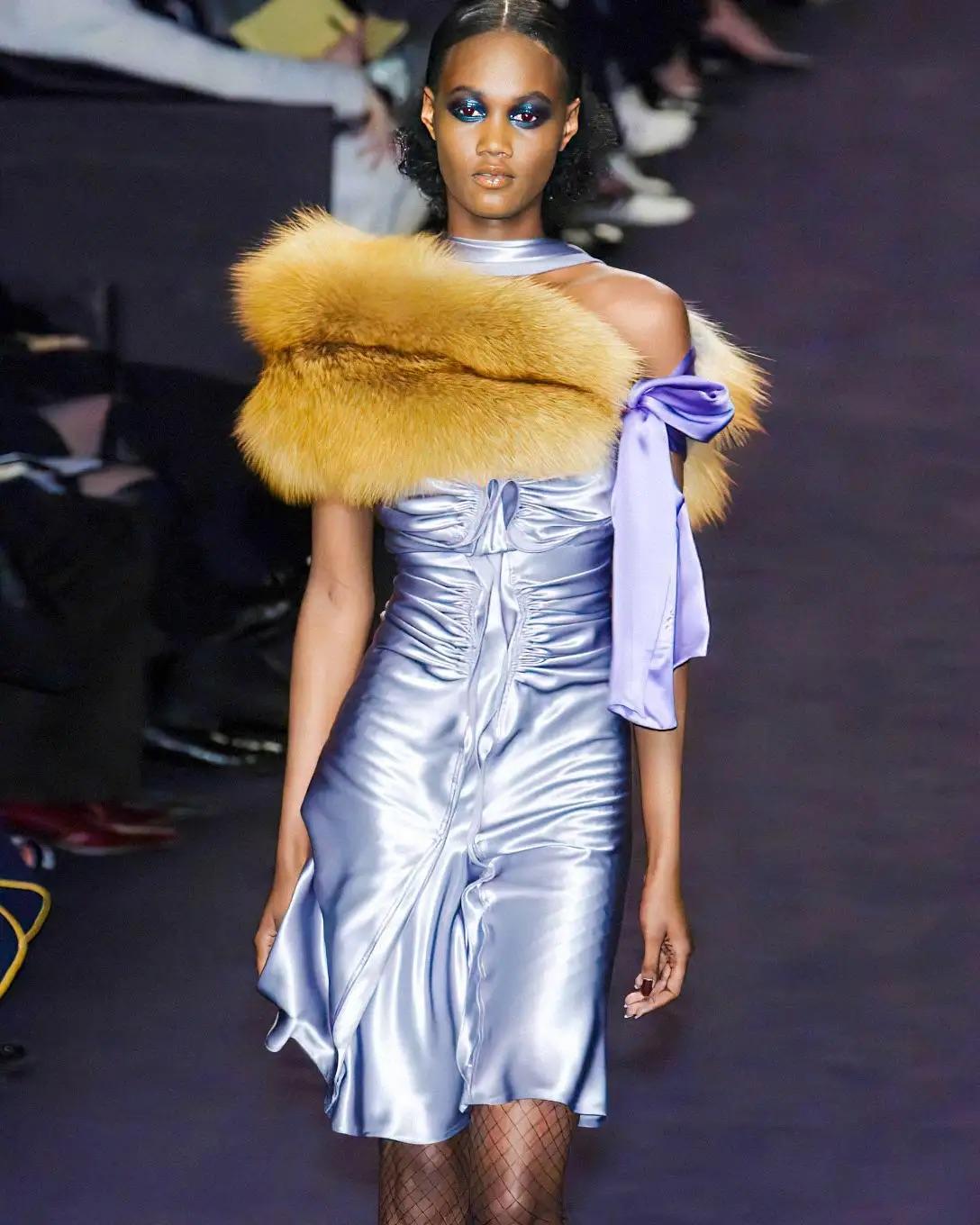 Introducing a stunning silver silk cocktail dress crafted by Tom Ford for Yves Saint Laurent Rive Gauche. This exquisite piece made its debut on the Fall/Winter 2003 runway, showcased as look number 26 on Valery Prince. It was later featured