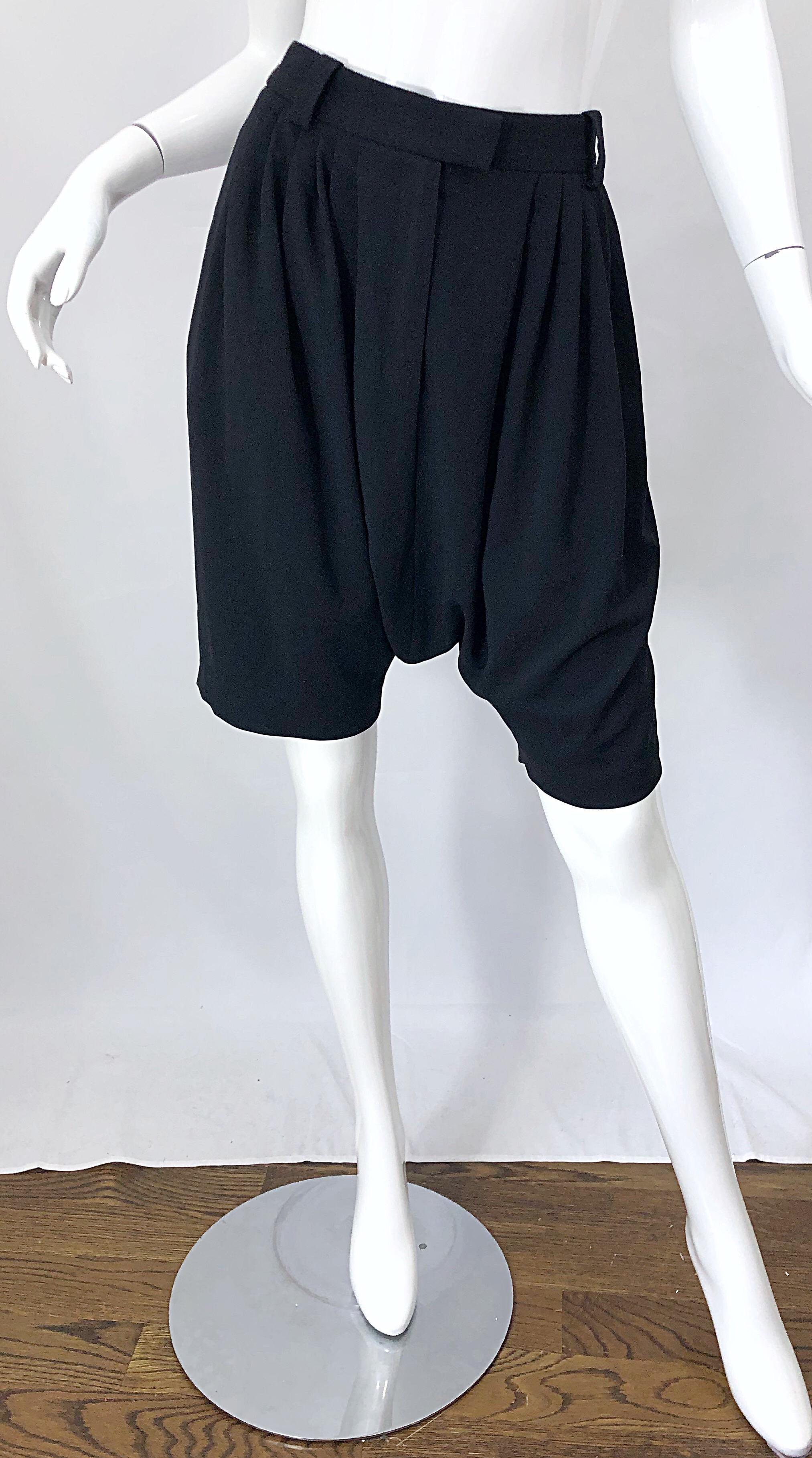 Chic brand new with tags GIVENCHY by Clare Waight Keller Size 40 black drop crotch / waist shorts! Features pleats, belt loops, and button closure at front center waist. POCKETS at each side of the hips. Can easily be dressed up or down. In great
