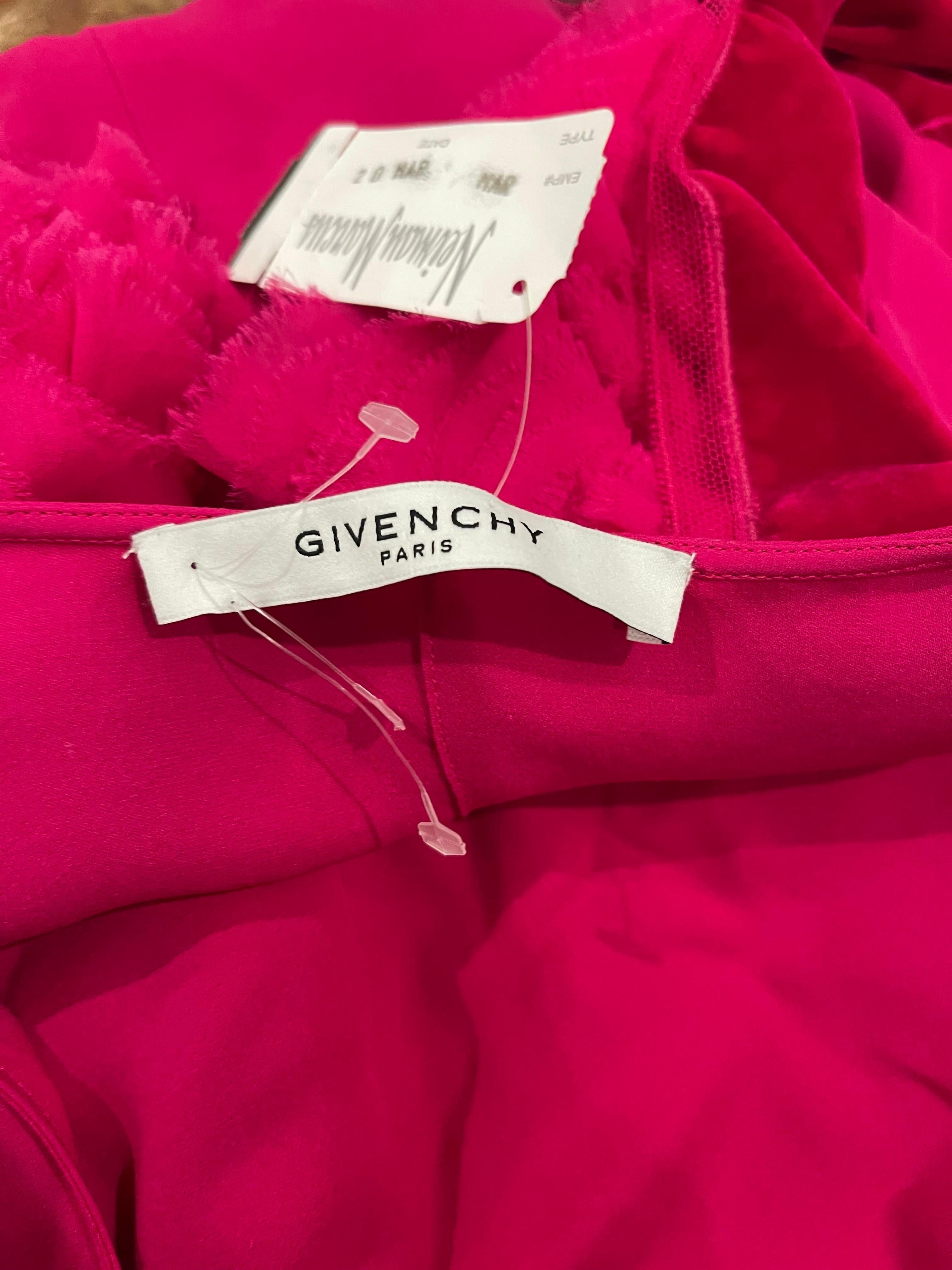 Chic brand new with store tags GIVENCHY S/S 2020 by Clare Waight Keller hot pink silk shirt ! Features an attached tie belt. Asymmetrical hem. Velvet details at each puff sleeve.
Simply slips over the head.
Can easily dress up or down. Pair with a