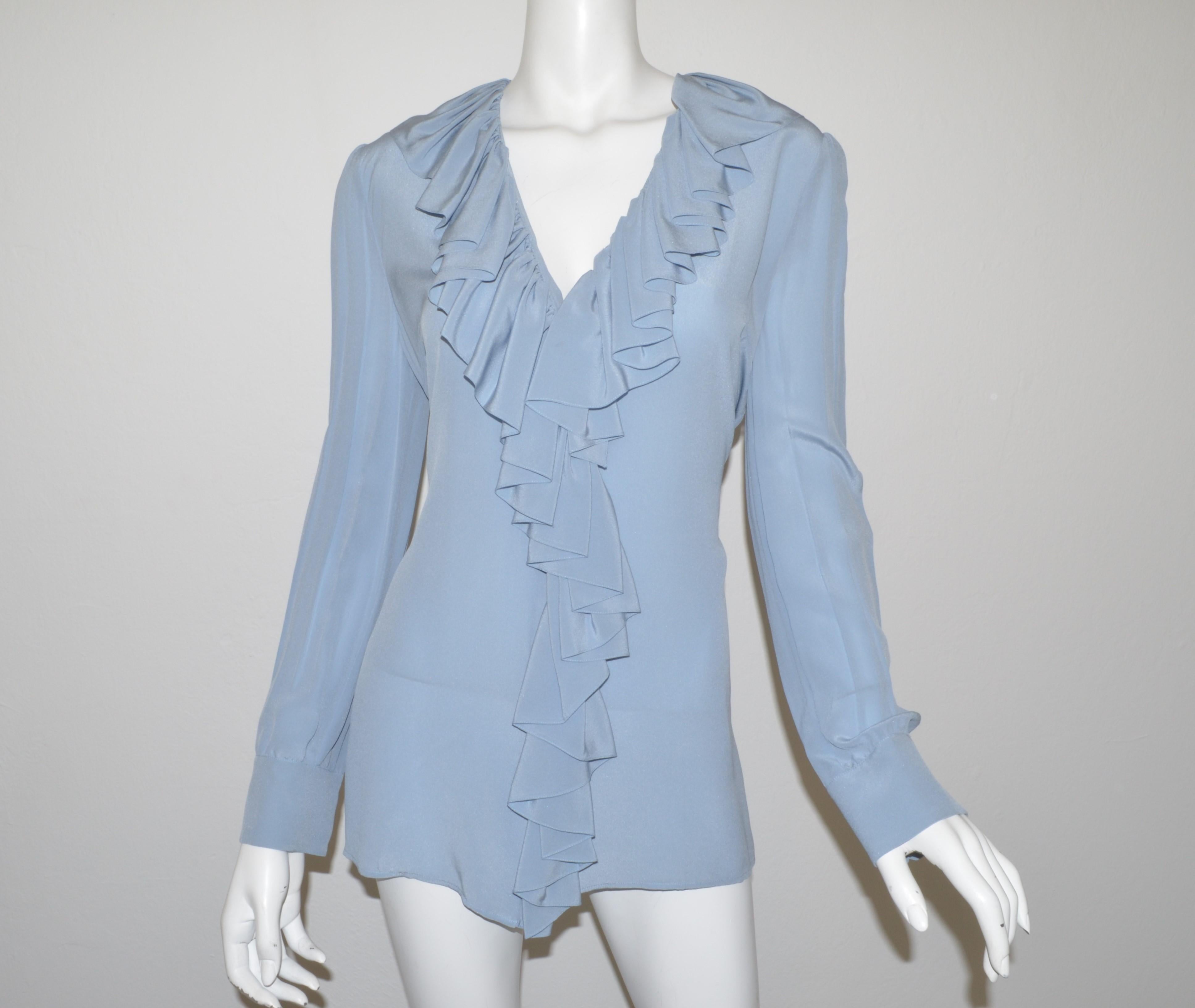 Gucci blouse featured in a powder blue color with concealed button closures, ruffled collar, and pearl buttons on the cuffs. Blouse is a size 44, composed with 100% silk.

Measurement:
Bust 42''
Sleeve 25''
Length 28''
Shoulder to shoulder 15''