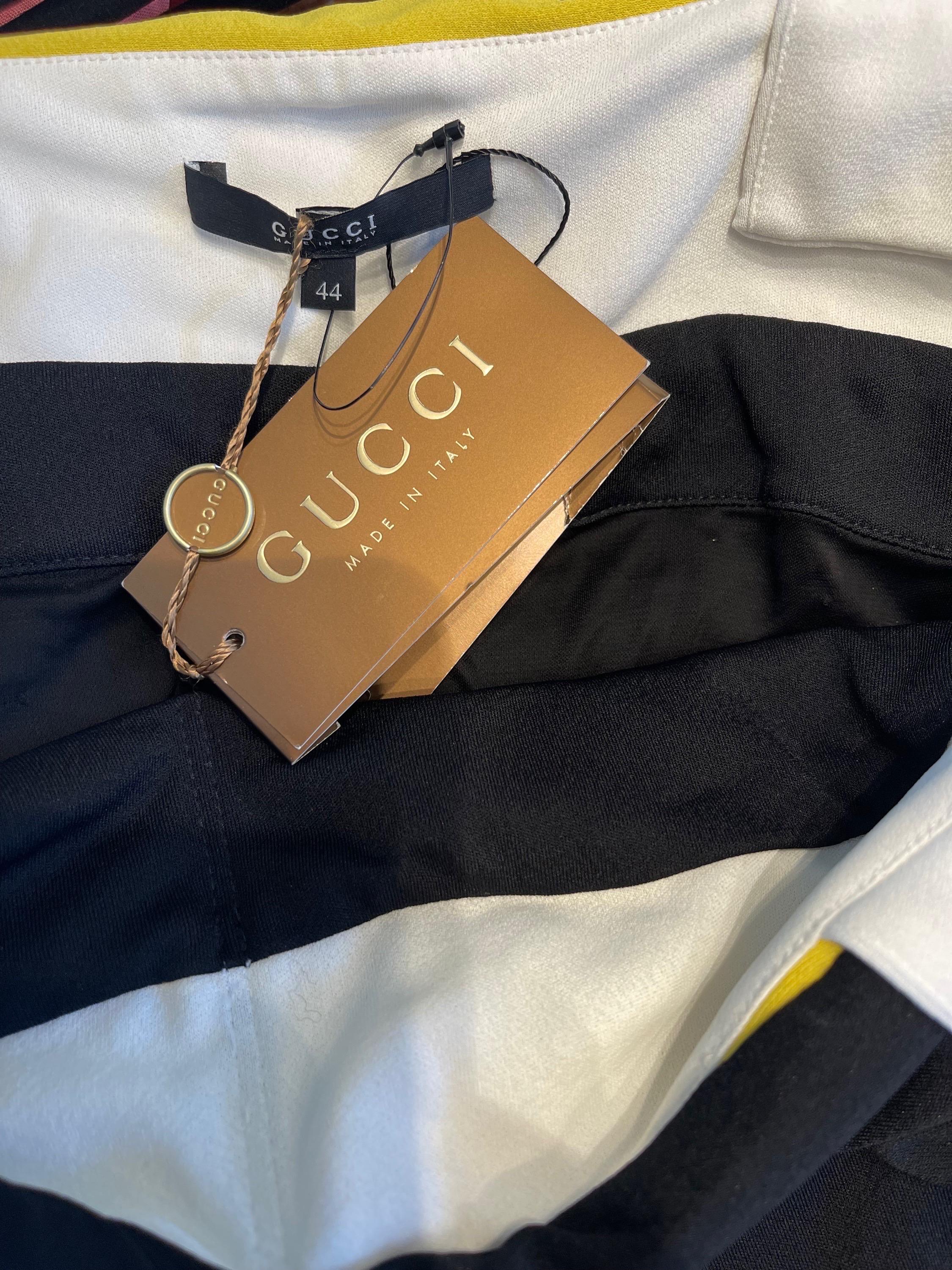 Chic brand new with tags GUCCI Spring 2008, by Frida Giannini dress ! Features a black body with white straps and a pop of yellow. Very flattering drapery is easy to wear. Hidden zipper up the side with hook-and-eye closure. Perfect for any day or