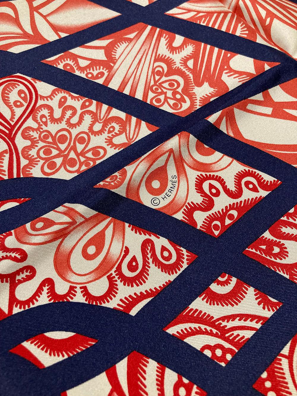 NWT Hermes Reverie Solitaire Silk Scarf in new unused condition. Silk screen design c2019 by Florence Manlik no longer available online. Red orange and pink abstract illustrated print with navy wavy line pattern over main design. Solid navy border