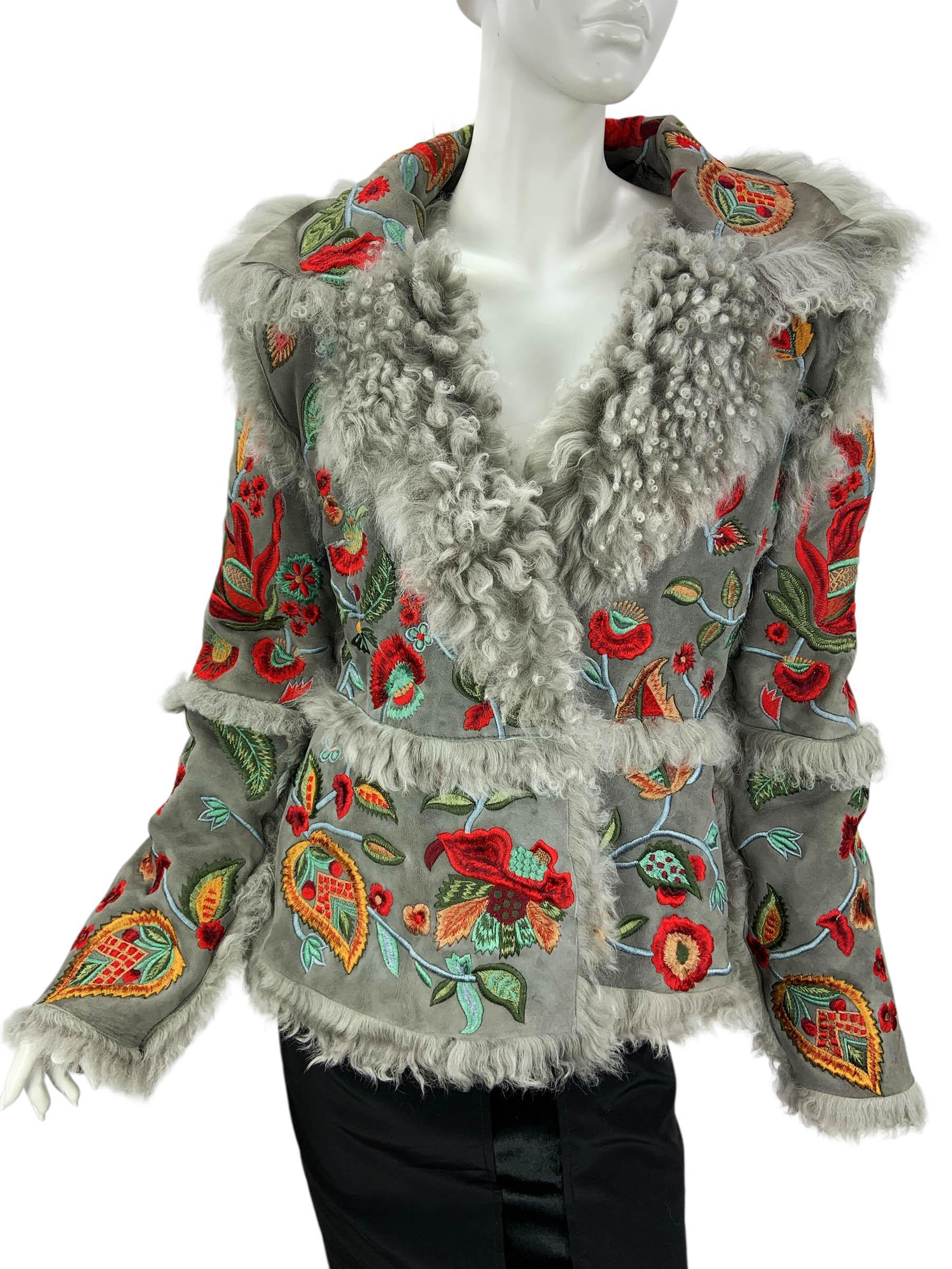 From Oscar de la Renta’s Fall 2013 collection, this exquisite jacket is crafted in sumptuous pearl gray shearling sourced from Spain. The design is richly embellished with vibrant floral embroidery in shades of red, green, turquoise, and gold,