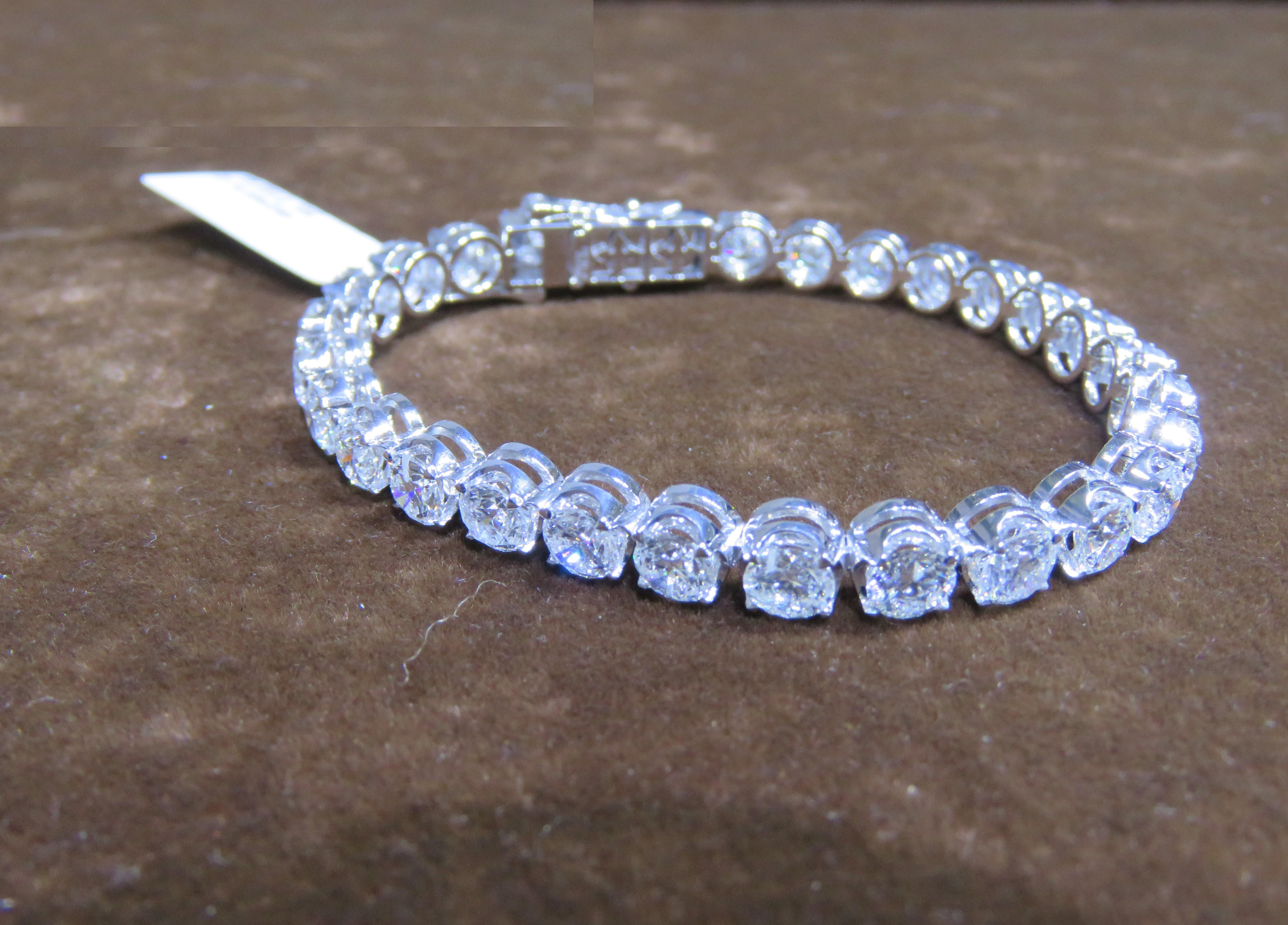 The Following Item we are offering is this Beautiful Rare Important 18KT White Gold Large Glittering Round Diamond Tennis Bracelet. Bracelet is comprised of over 25CTS Magnificent Rare Gorgeous Fancy Glittering Round Diamonds!!! The Diamonds are of