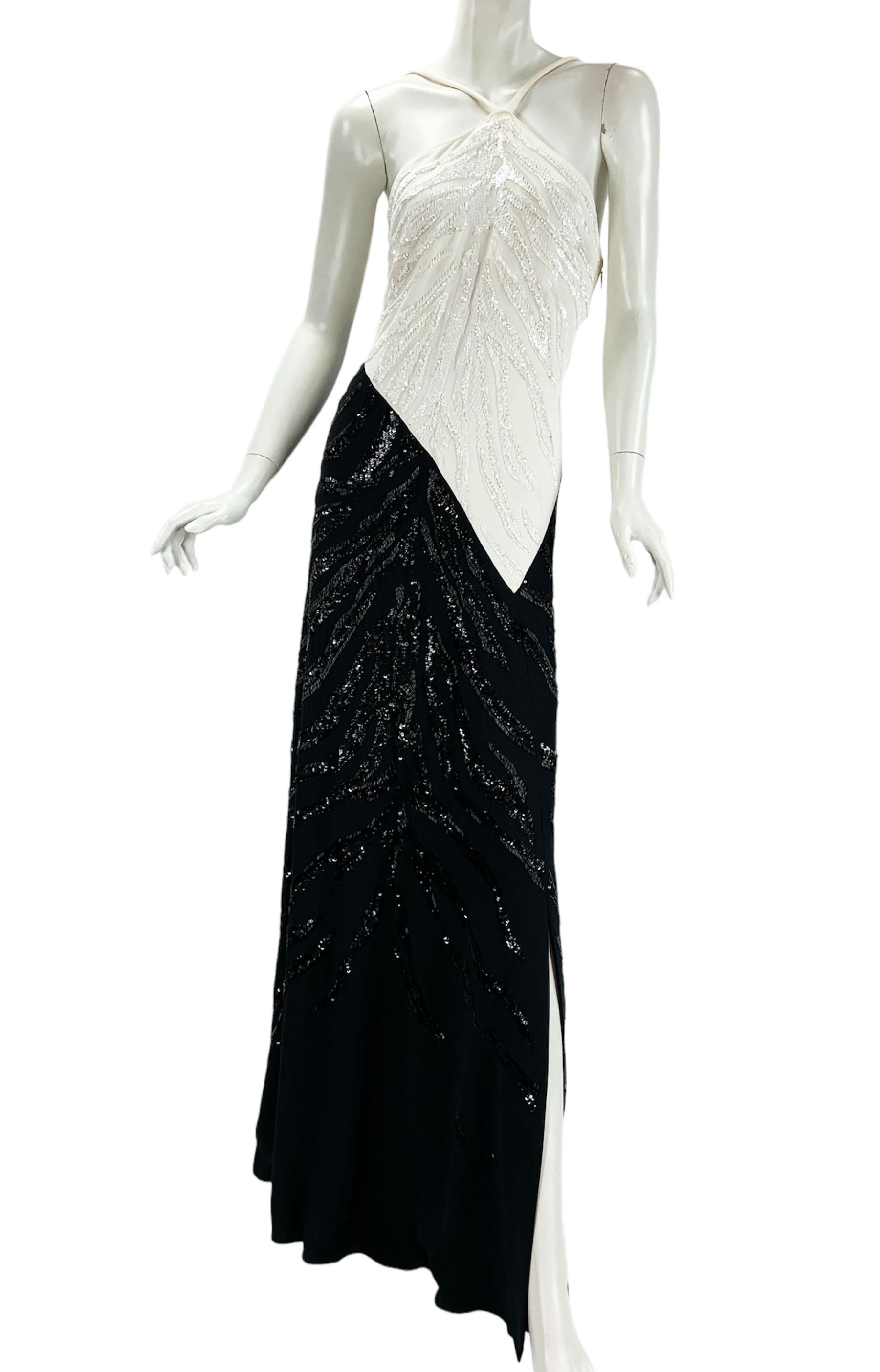 New Roberto Cavalli Fully Embellished Dress Gown
Italian size 44 ( US 8/10 ) - please check measurements.
Classic combination of white and black, fully embellished with beads and sequins, side slit, fully lined in silk, fabric stretchy.
95% Viscose,