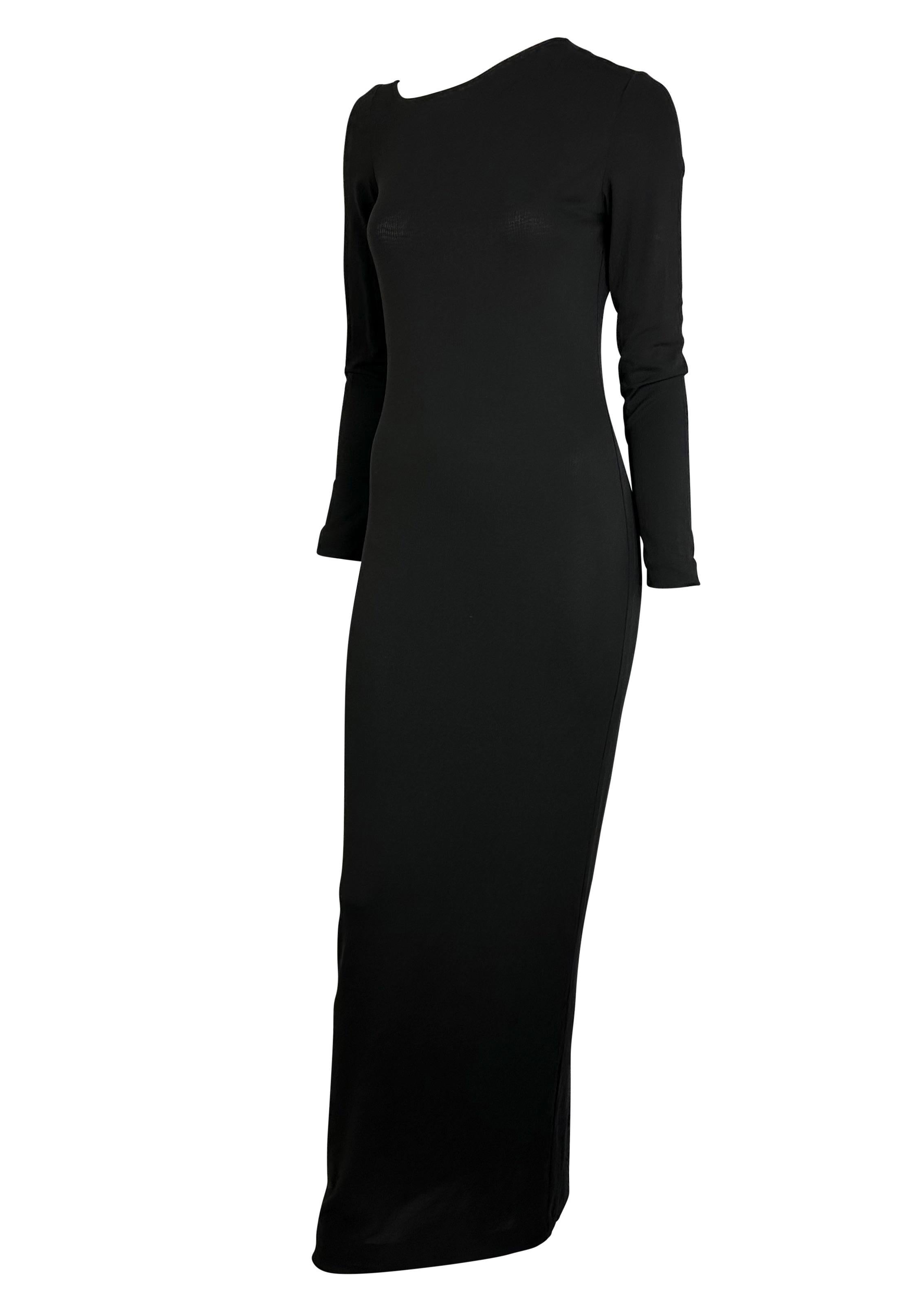 Presenting an incredible black viscose Gucci gown, designed by Tom Ford. From the Spring/Summer 1998 collection, this long sleeve dress perfectly drapes on the wearer's body with a semi-sheer viscose jersey that provides a water-like effect. This