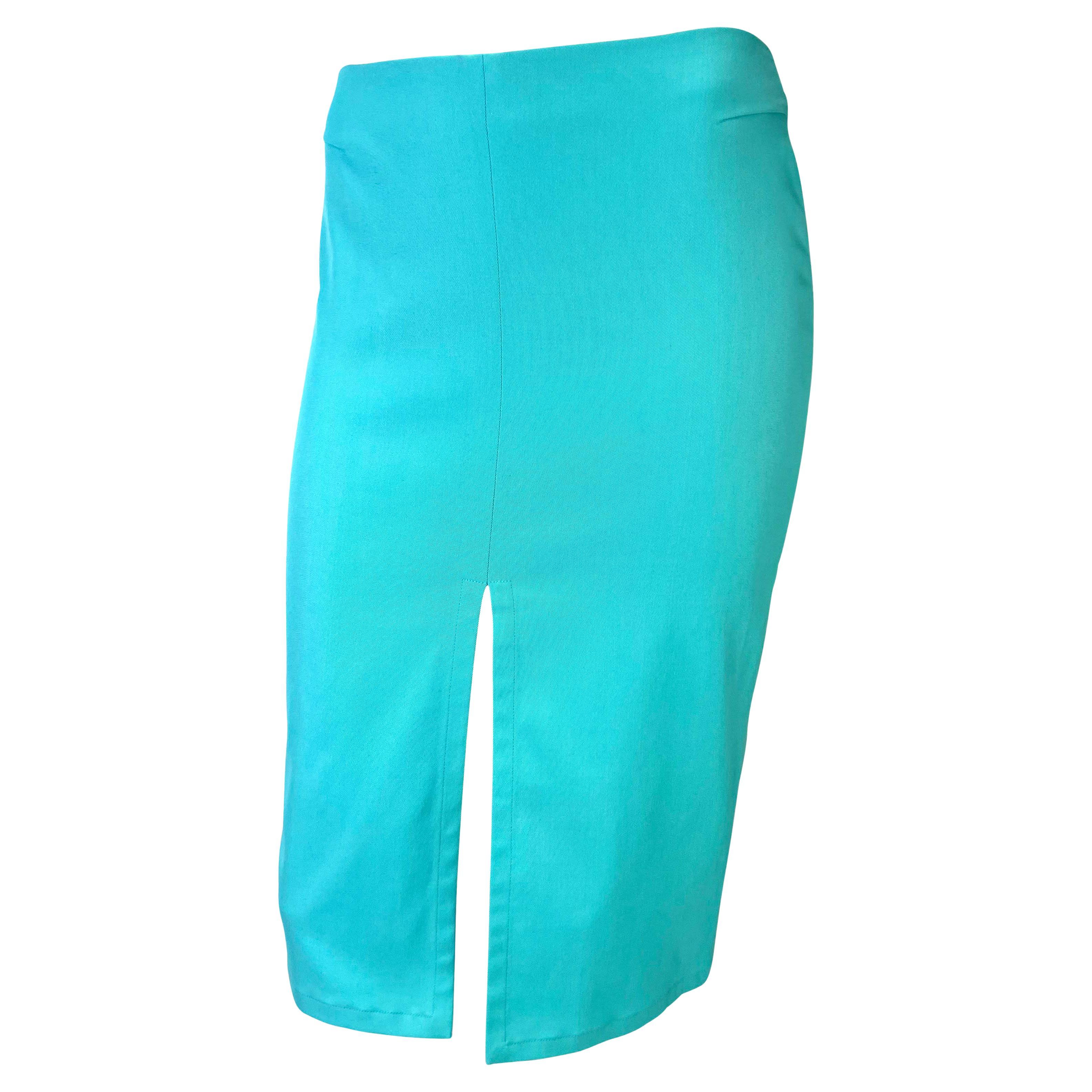 TheRealList presents: a sleek turquoise skirt designed by Tom Ford for Gucci's Spring/Summer 2000 collection. The unique mirrored slit at the front and back of the skirt creates a flirty split that almost creates a mini skirt silhouette. The bold