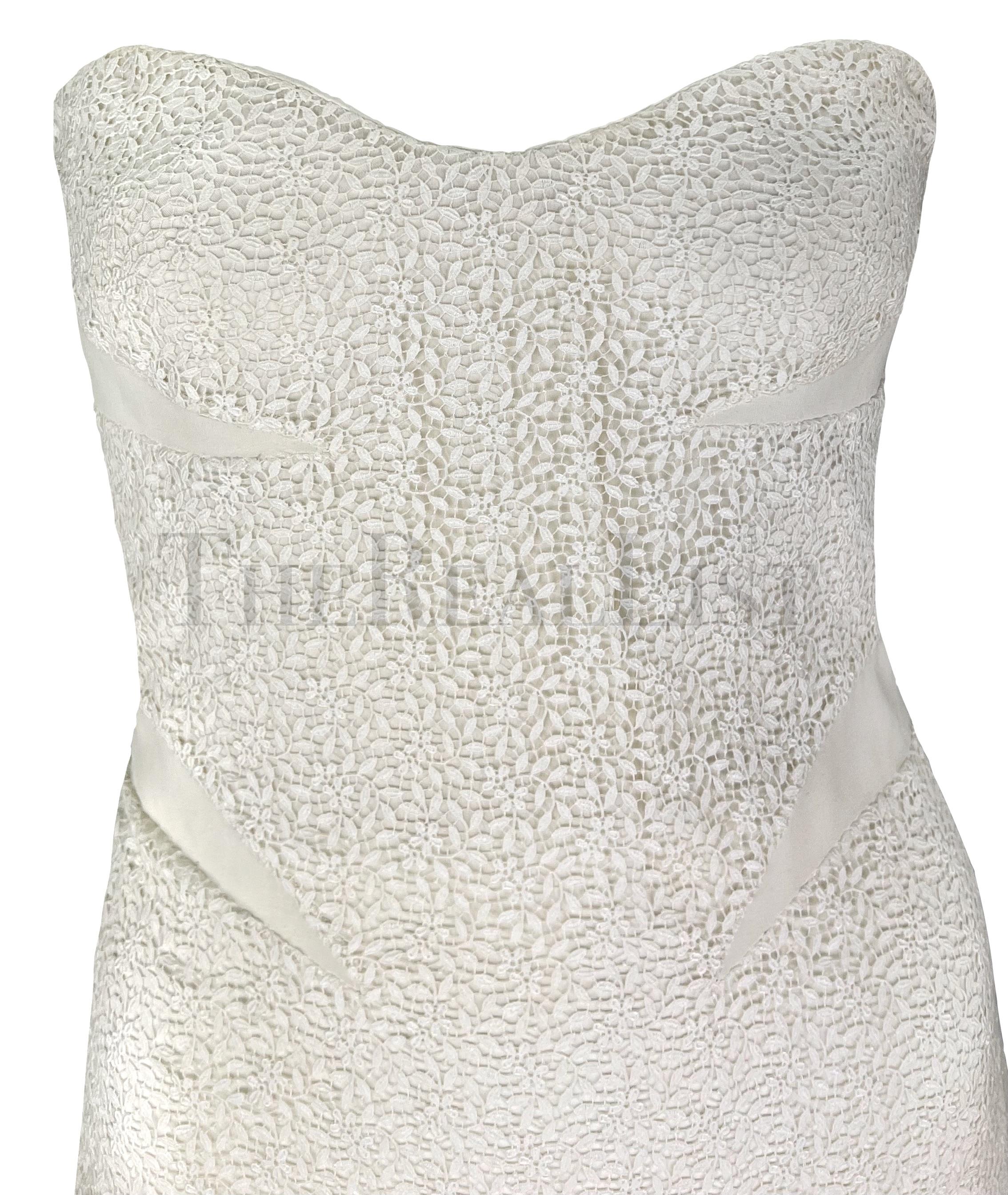 Presenting a beautiful white lace Gianni Versace strapless dress, designed by Donatella Versace. From the Spring/Summer 2002 collection, this dress is constructed entirely of floral lace and features solid white panels that add shape to the dress.