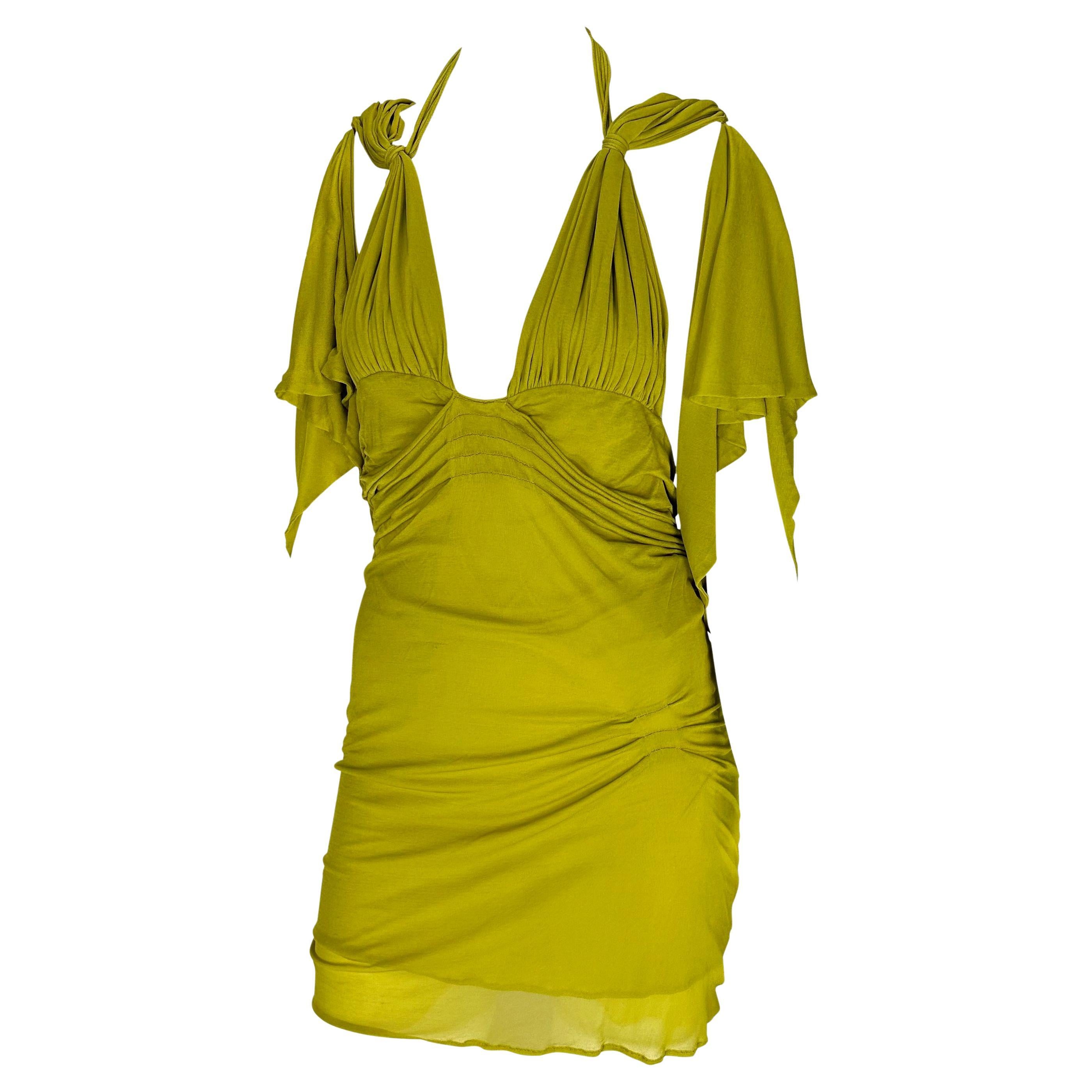 Presenting a fabulous green silk Gucci mini dress, designed by Tom Ford. From the Spring/Summer 2003 collection, this unique dress features areas of ruching and pleating throughout, flowy sleeves, and an exposed back. Never worn before, this sexy