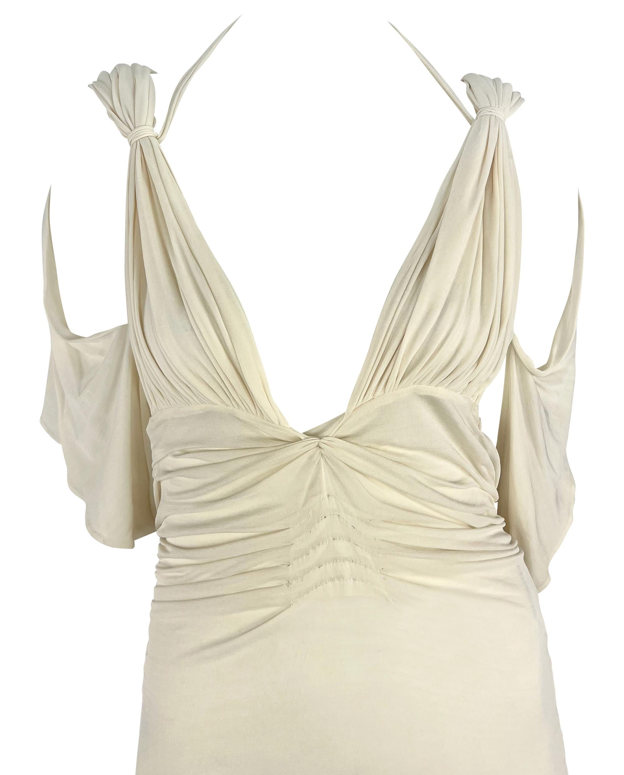 Presenting a fabulous white silk Gucci gown, designed by Tom Ford. From the Spring/Summer 2003 collection, this unique dress features ruching and pleating throughout, flowy sleeves, and an exposed back. Never worn before, this sexy sample dress is