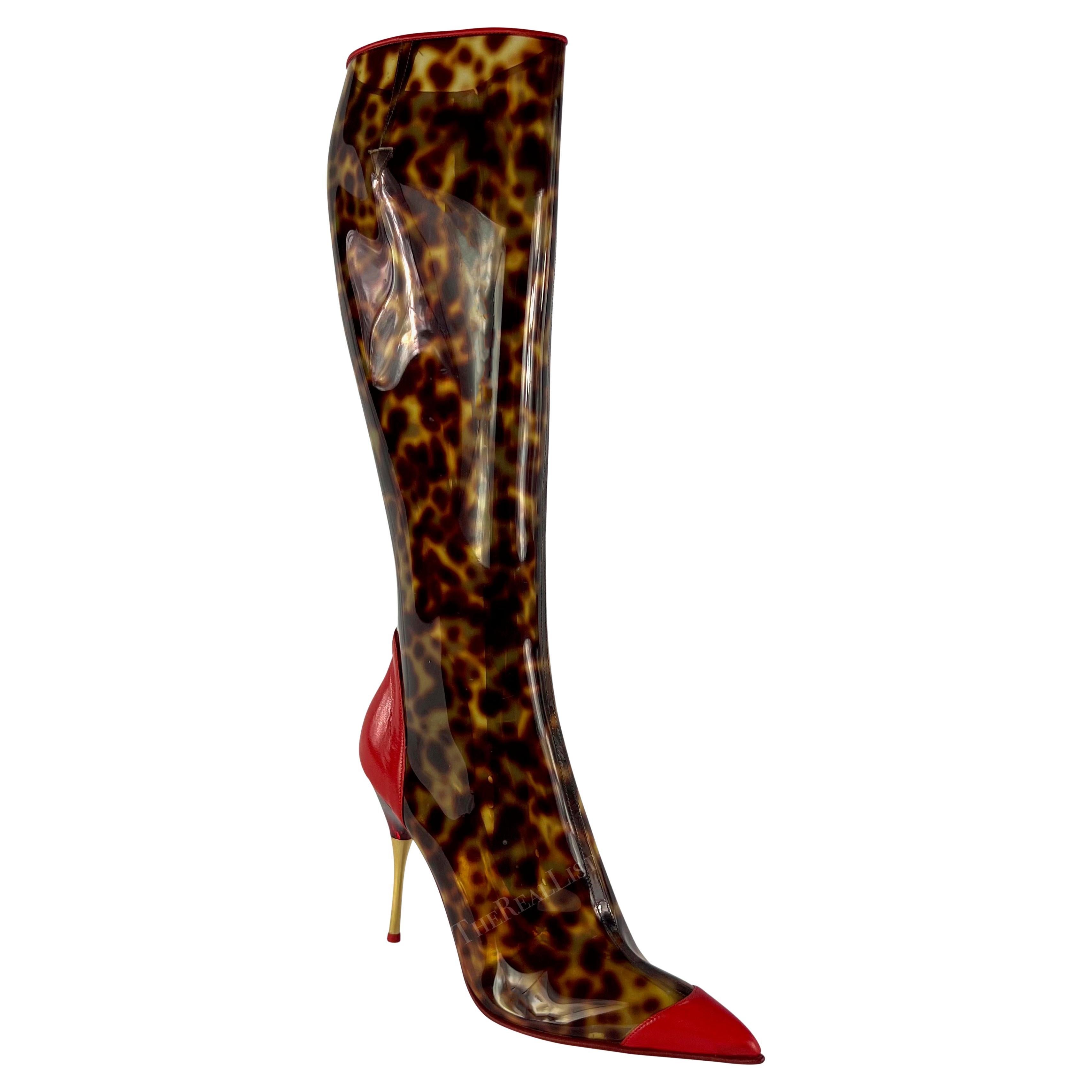 Presenting a pair of spotted brown PVC Roberto Cavalli heeled boots. From the Spring/Summer 2003 collection, these fabulous boots are constructed of spotted brown PVC, reminiscent of tortoiseshell, and feature bright red leather accents. Never worn