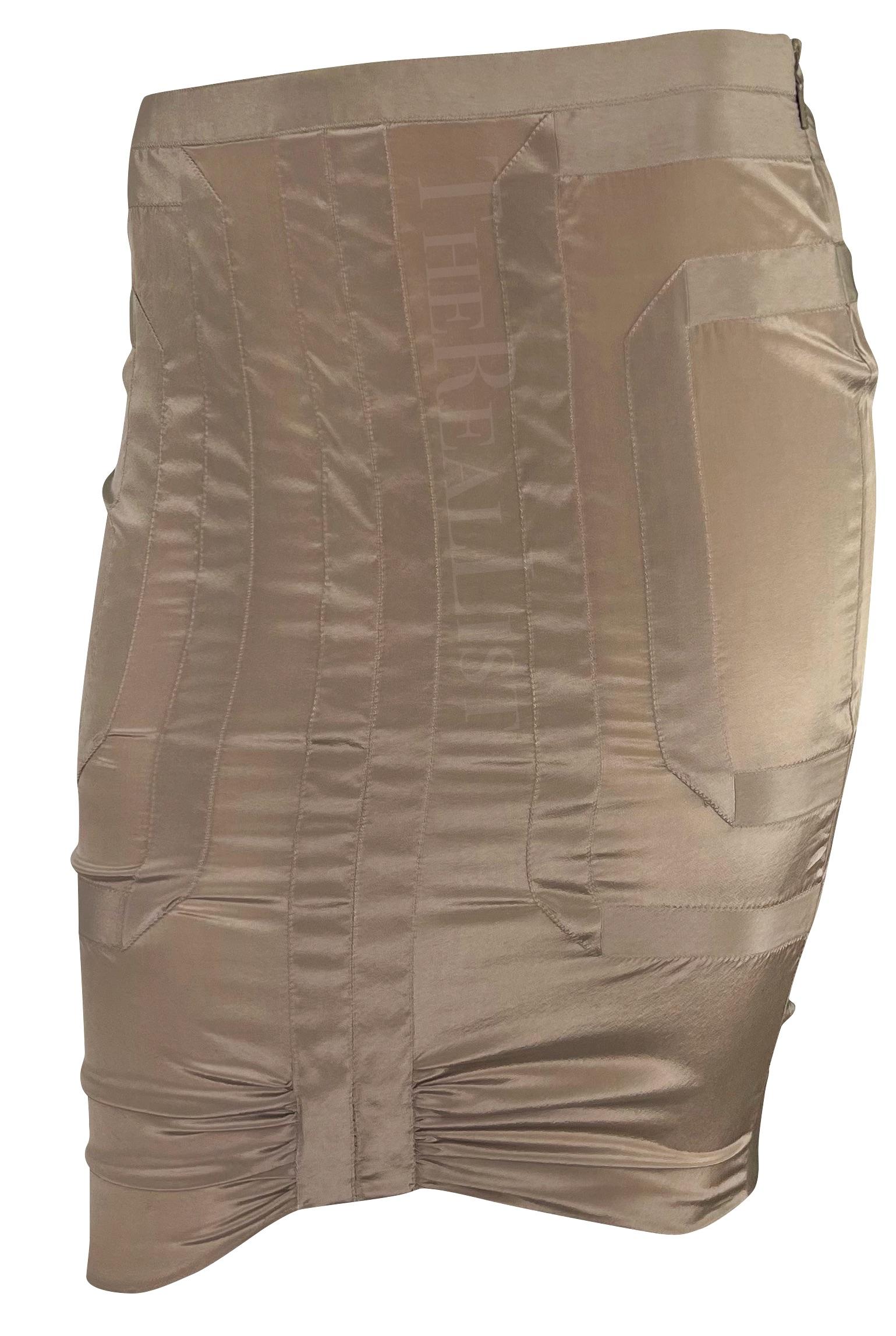 Presenting a beautiful taupe Gucci skirt, designed by Alessandra Facchinetti. From the Spring/Summer 2005 collection, this chic satin skirt showcases angular ribbon accents and delicate ruching above the hem, exuding modern allure. Preserved with