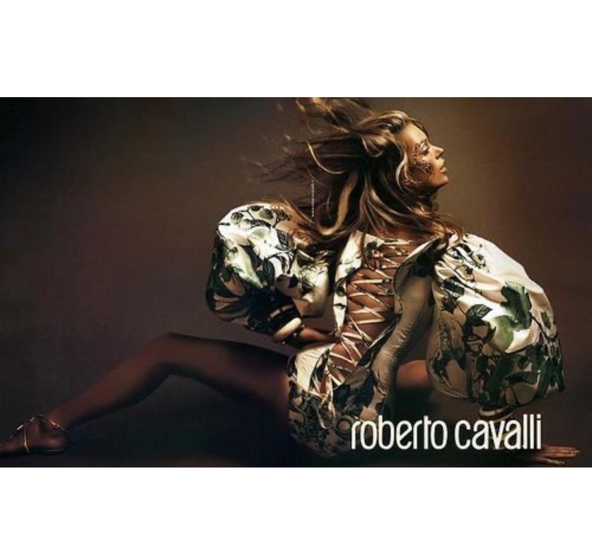 Presenting a stunning asymetrical Roberto Cavalli corset with exaggerated poof sleeves. From the Spring/Summer 2005 collection, this fabulous top debuted on the season's runway as part of look 4 modeled by Carmen Kass and was also highlighted in the